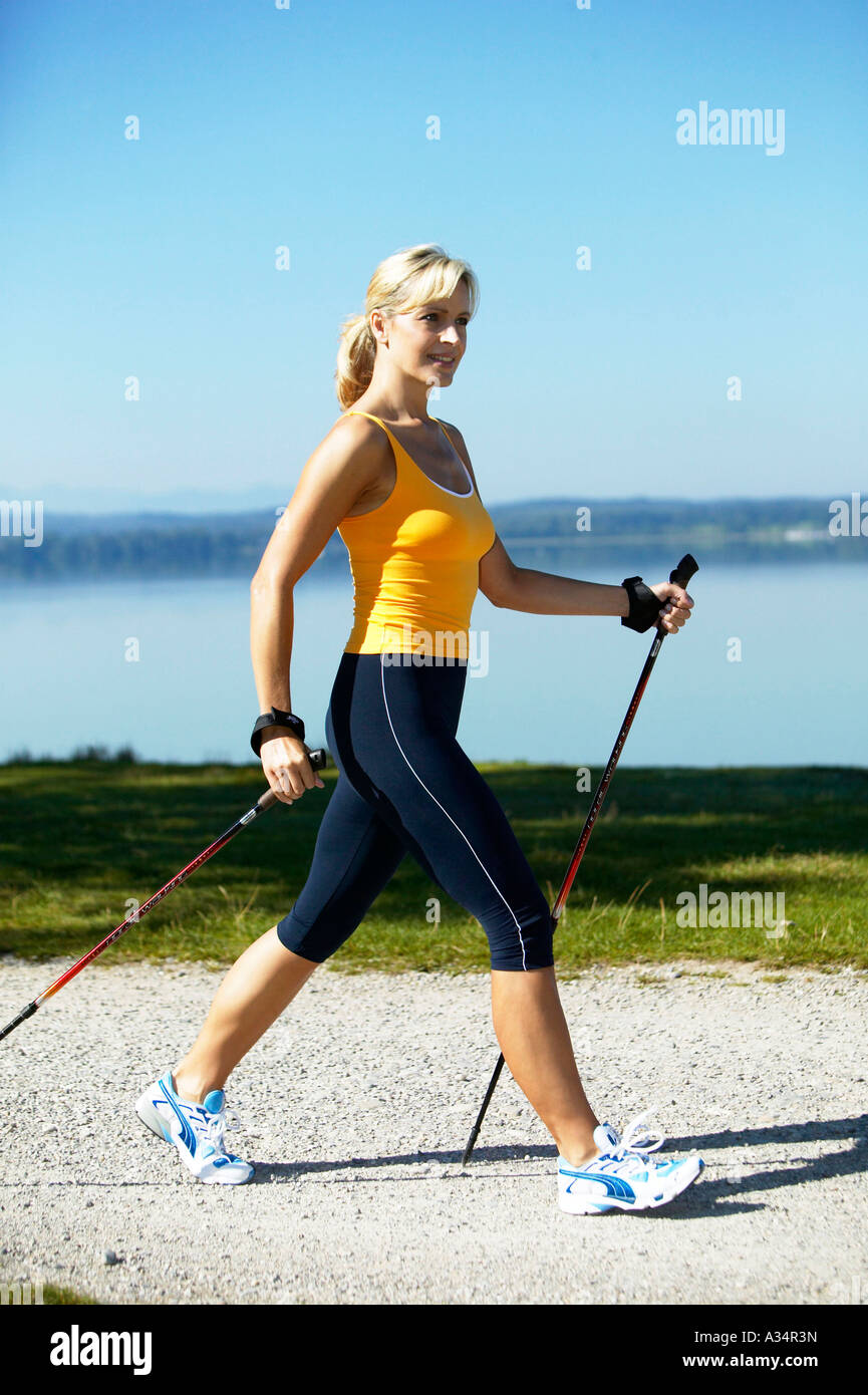 woman doing nordic walking, blonde Frau beim Nordic Walking Stock Photo ...