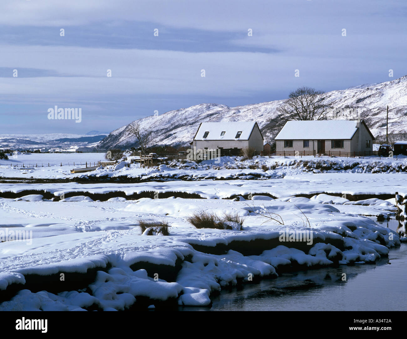 Cottages by Glenmore River in Galltair with snow on ground in winter Glenelg Highland Scotland Stock Photo