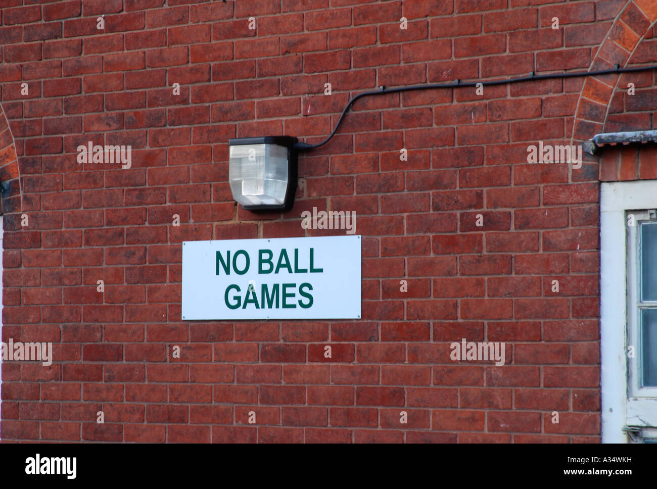 Sign on side of building prohibiting the playing of ball games Stock Photo