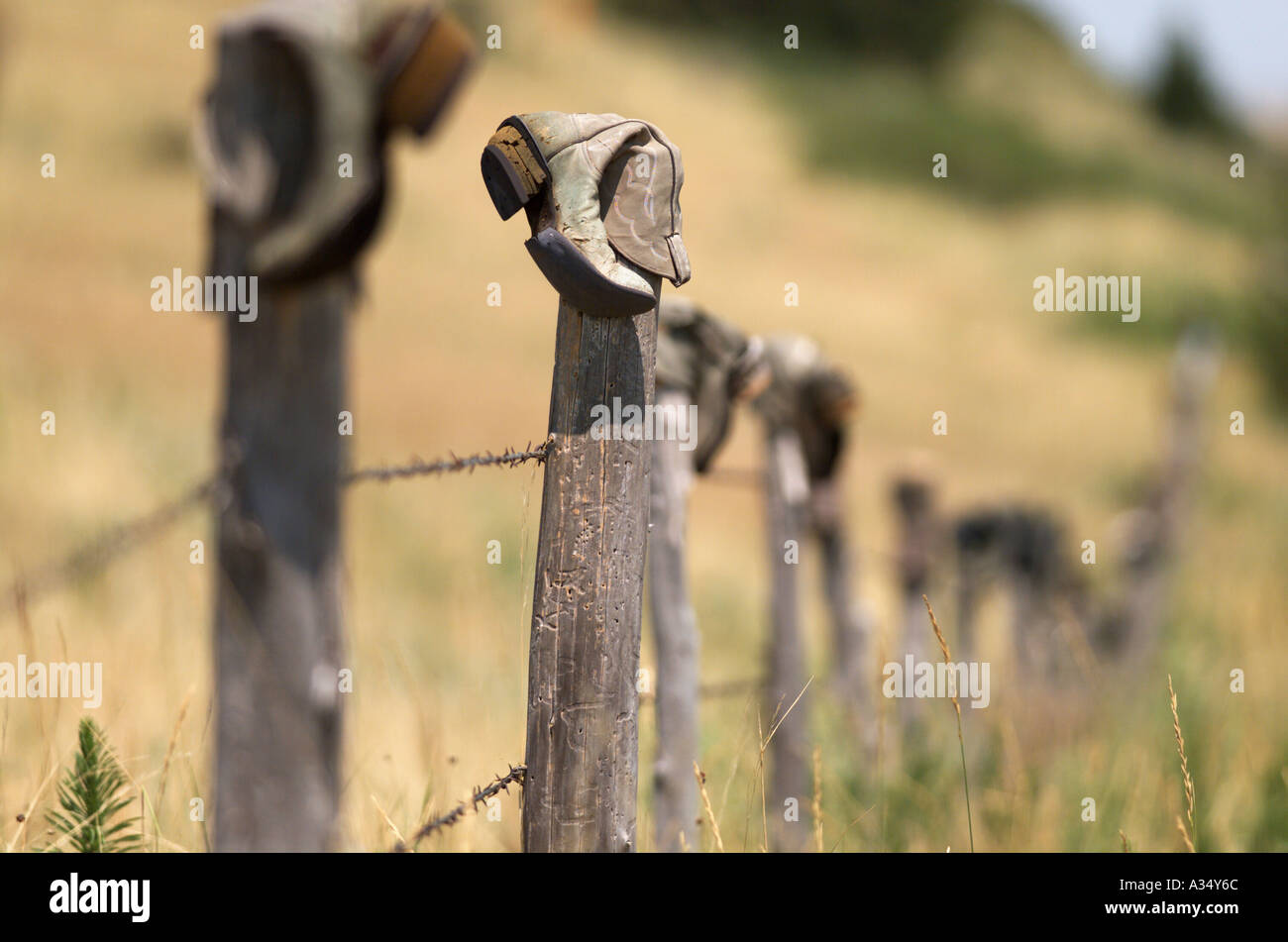 A tradition in the west discarded cowboy boots hang on an old fencepost