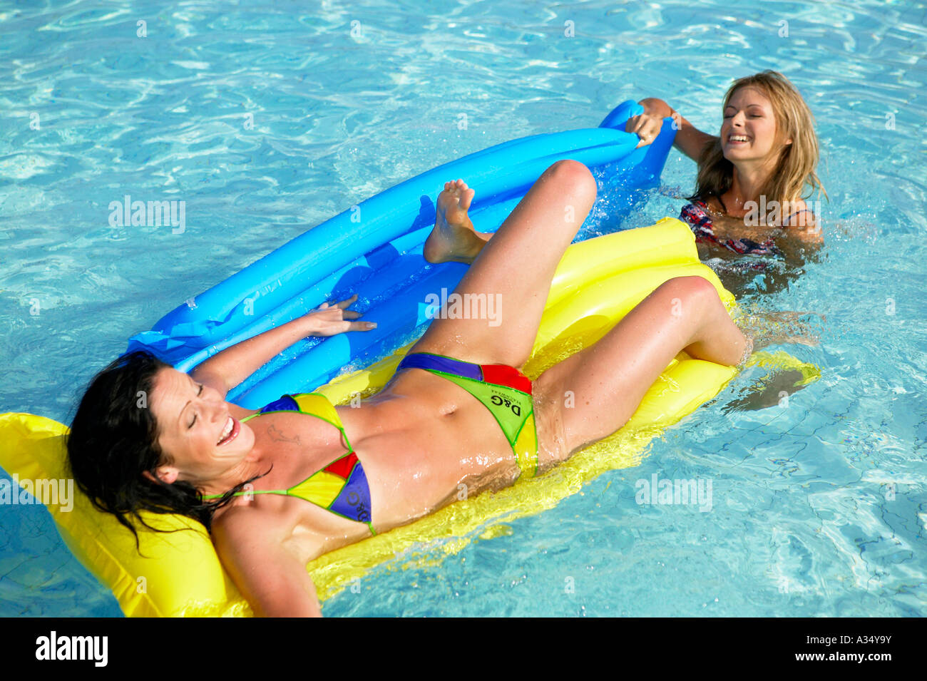 Blonde lesbian teens in the pool