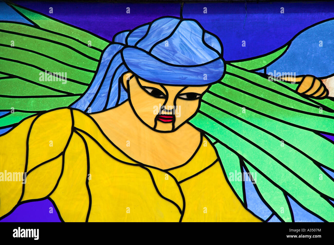 Colourful stained glass window of woman carrying farming produce on her
