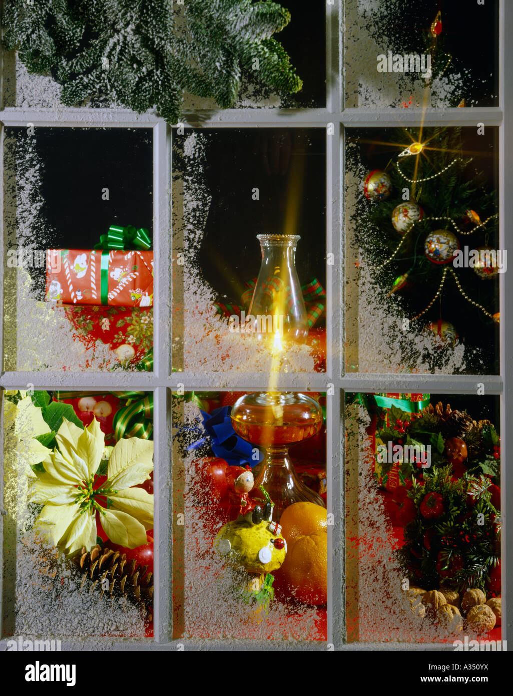 Snowcovered window at Christmas with holiday scene inside Stock Photo