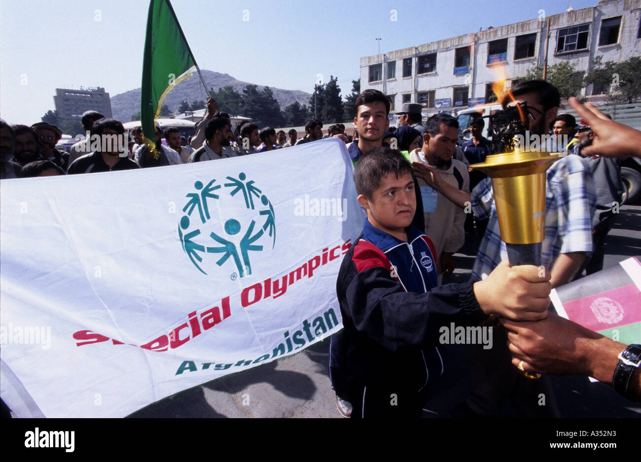 A mental disabled athlete is taking the Olympic's torch during the opening day of Special Olympics Afghanistan in Kabul. Stock Photo