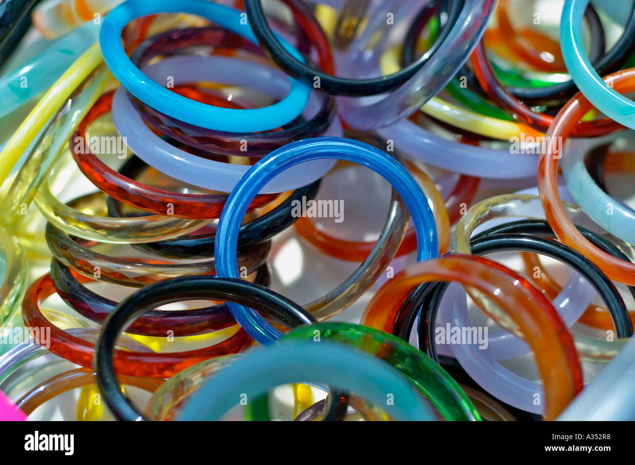 A colorful pile of plastic bracelets in a vendor's bin. Stock Photo