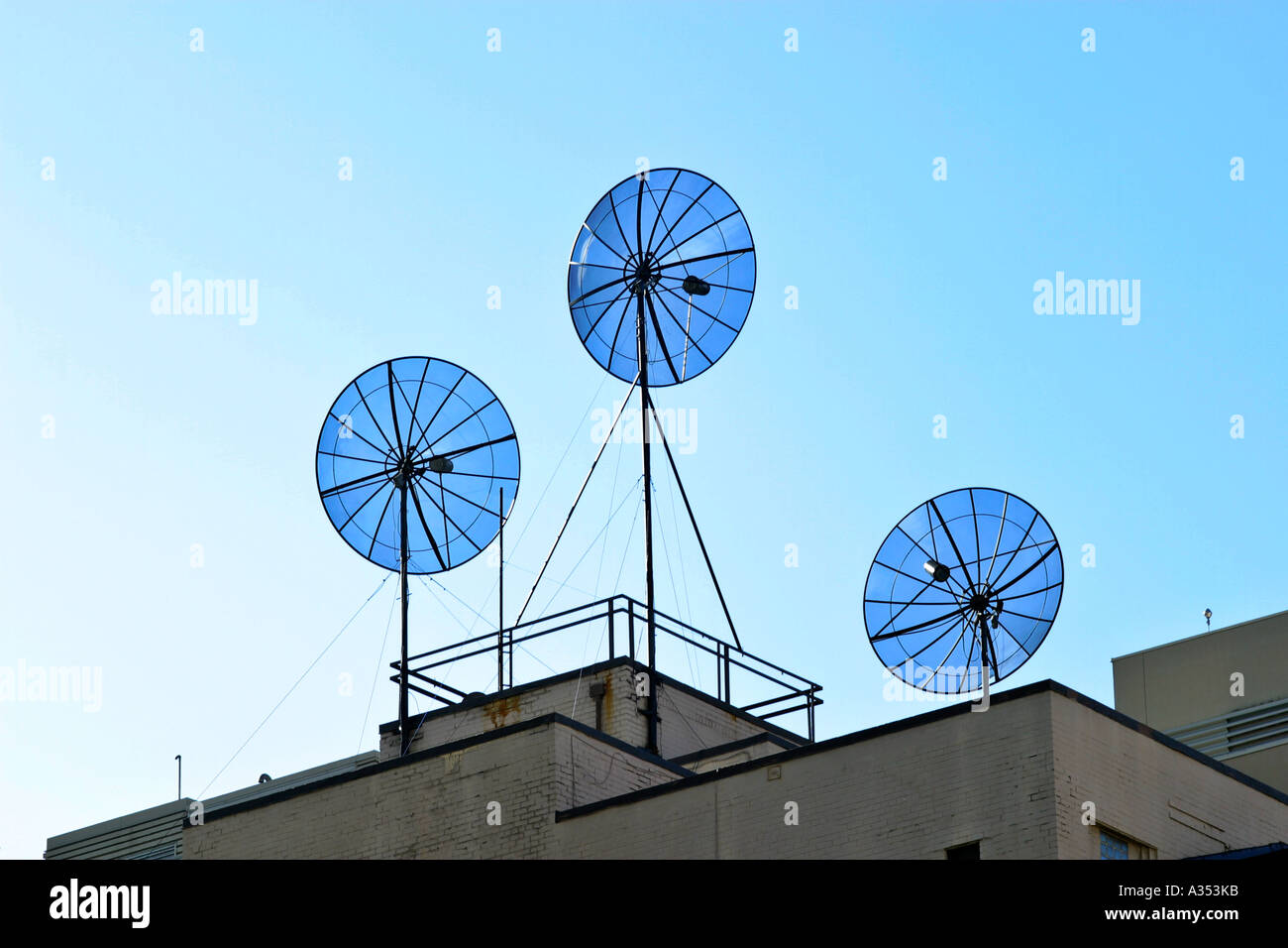 Satellites on a rooftop, against perfectly blue sky. Stock Photo