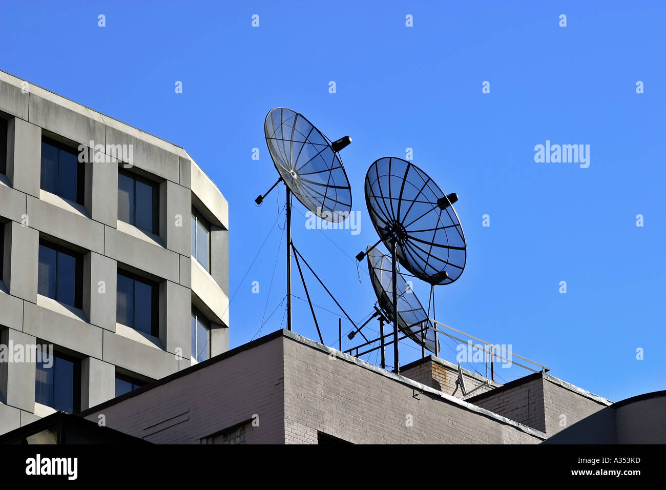 Satellites on a rooftop, against perfectly blue sky. Stock Photo