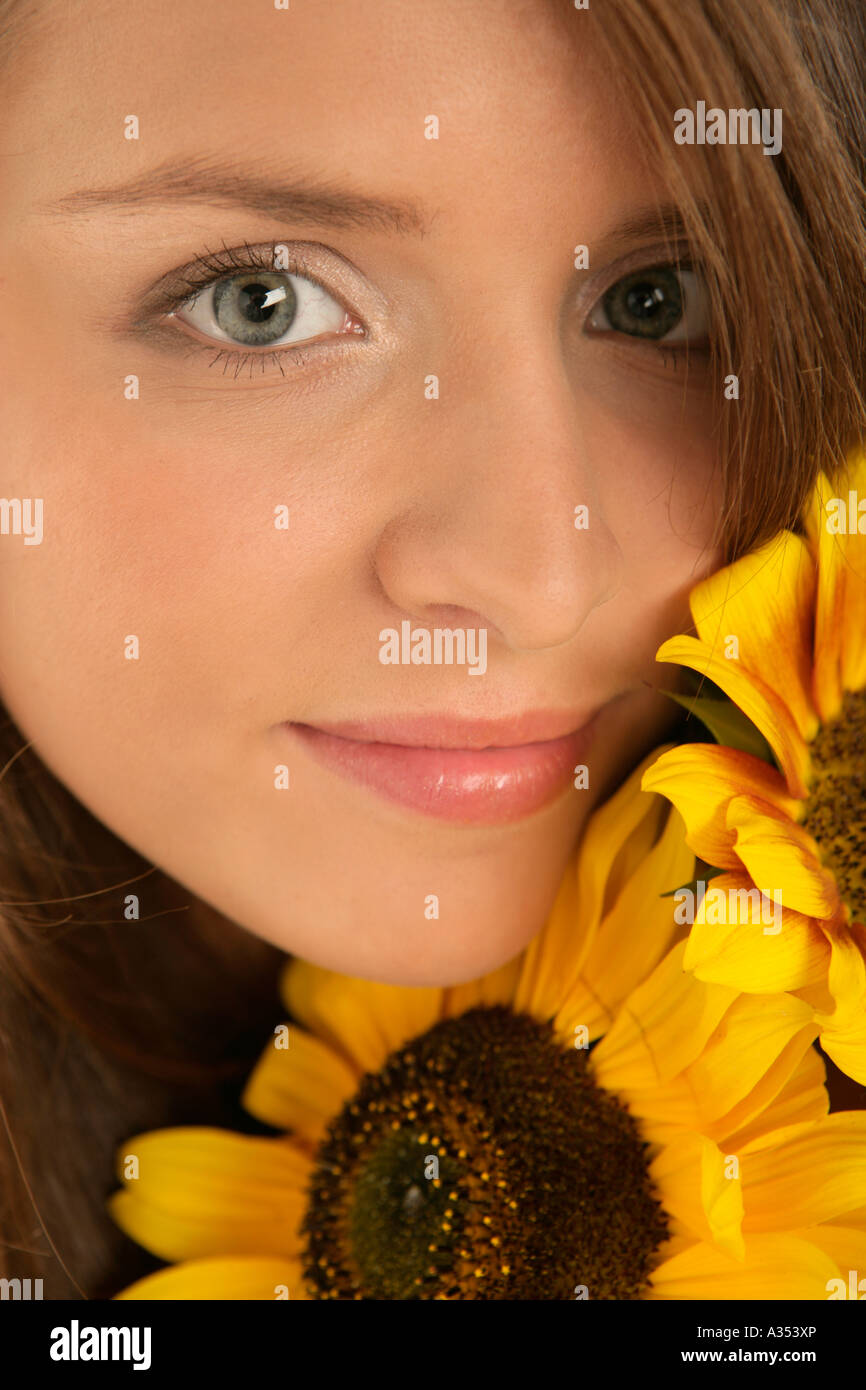 Portrait of young woman with sunflowers Stock Photo - Alamy