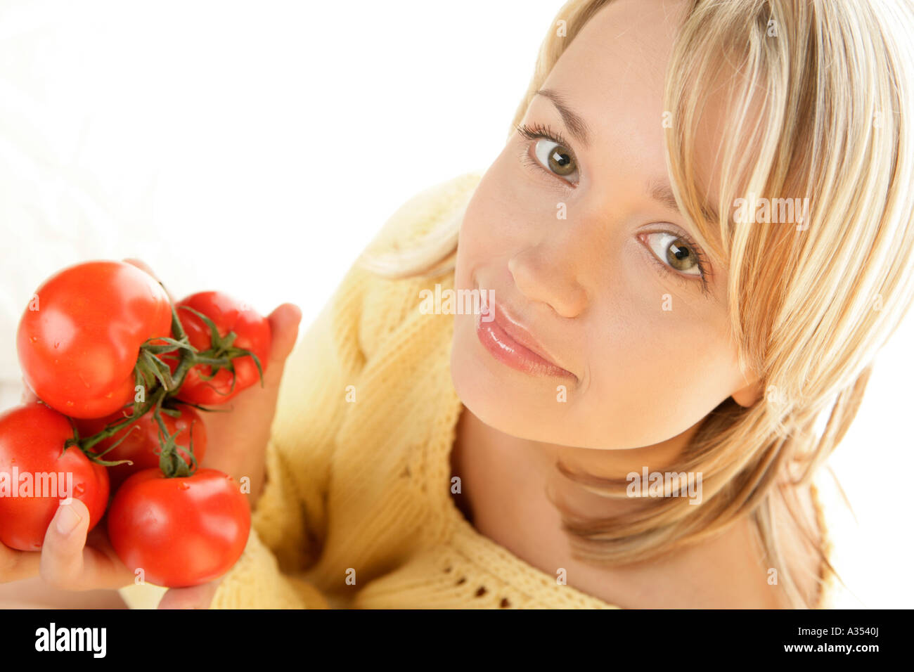 Woman holding bunch of tomatoes Stock Photo - Alamy