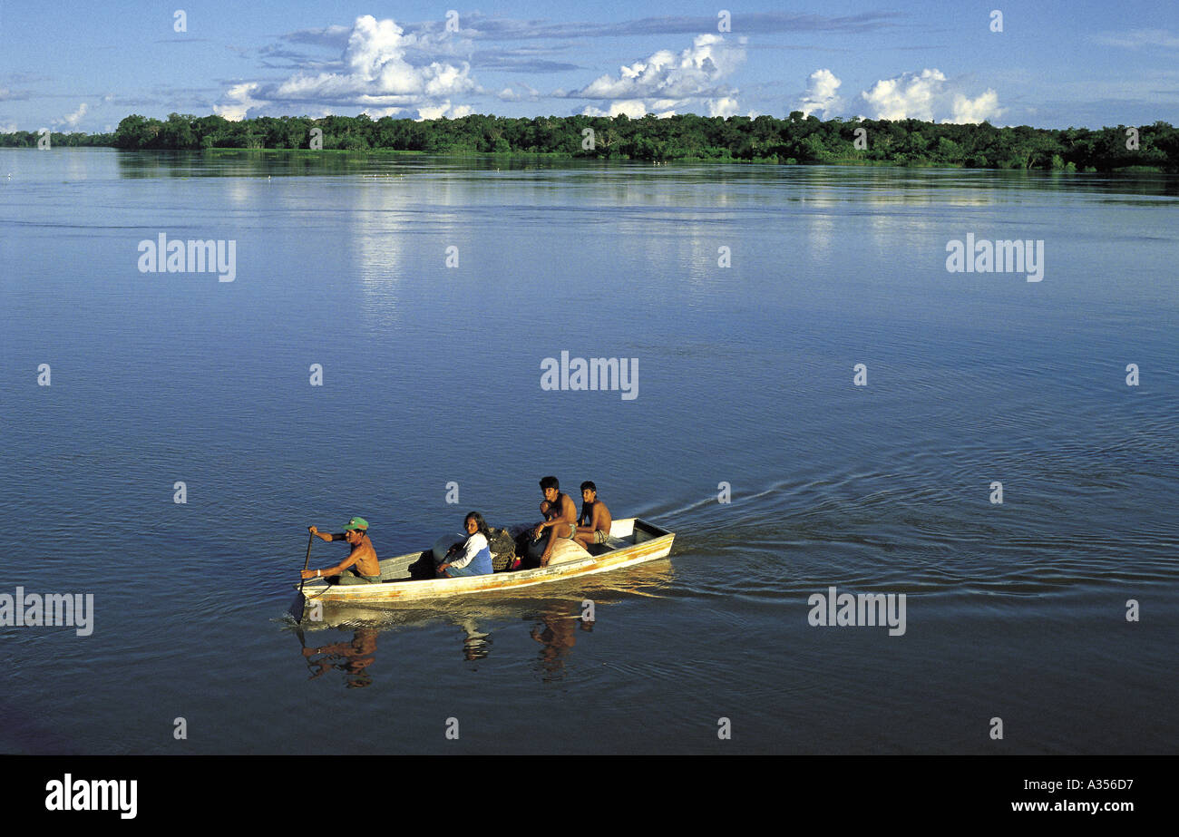 Rio Negro Brazil Amazon caboclo family paddling a small canoe Amazonas State Stock Photo