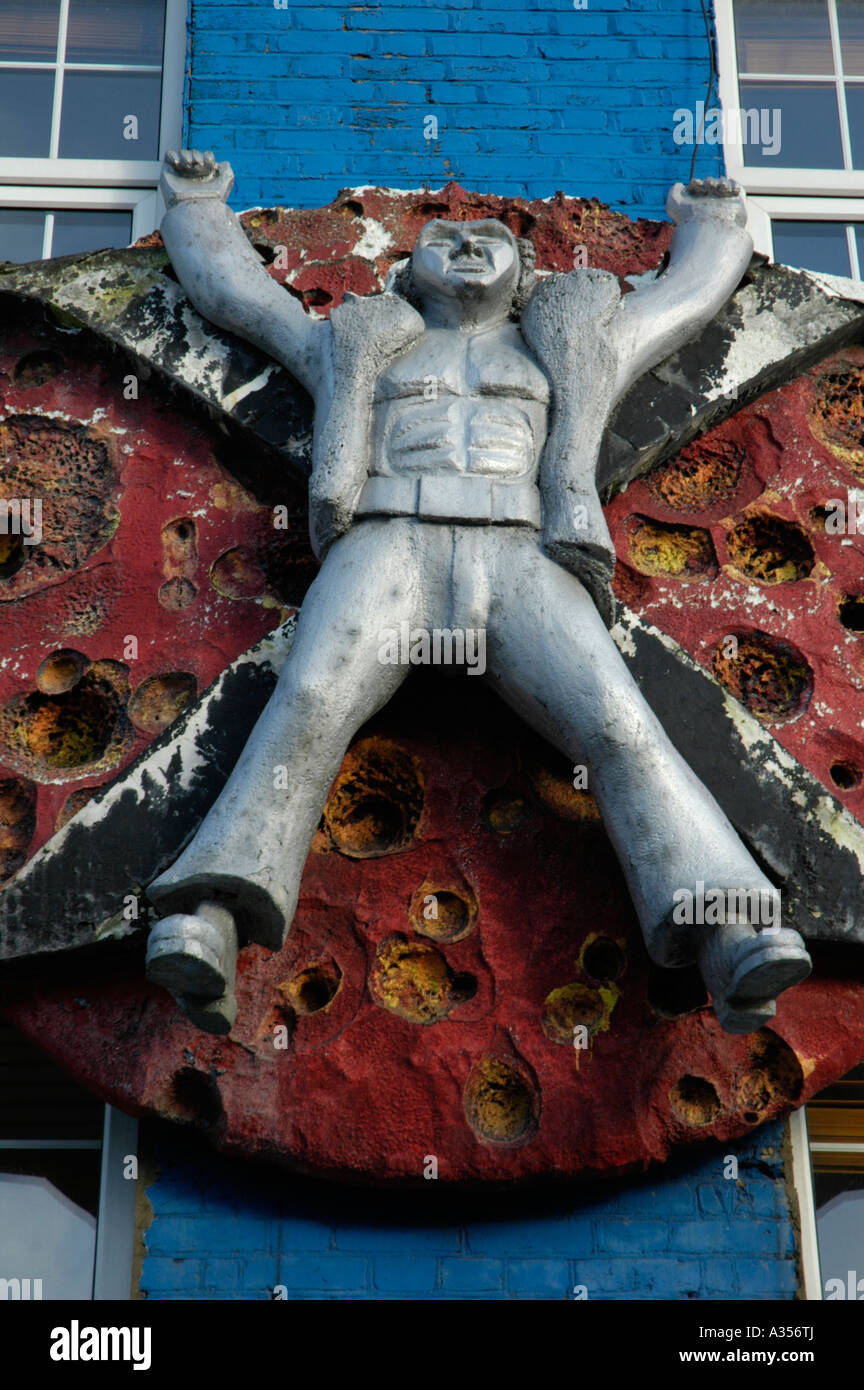 Figure of man with arms outstretched above fashion boutique Chalk Farm Road Camden Town London Stock Photo