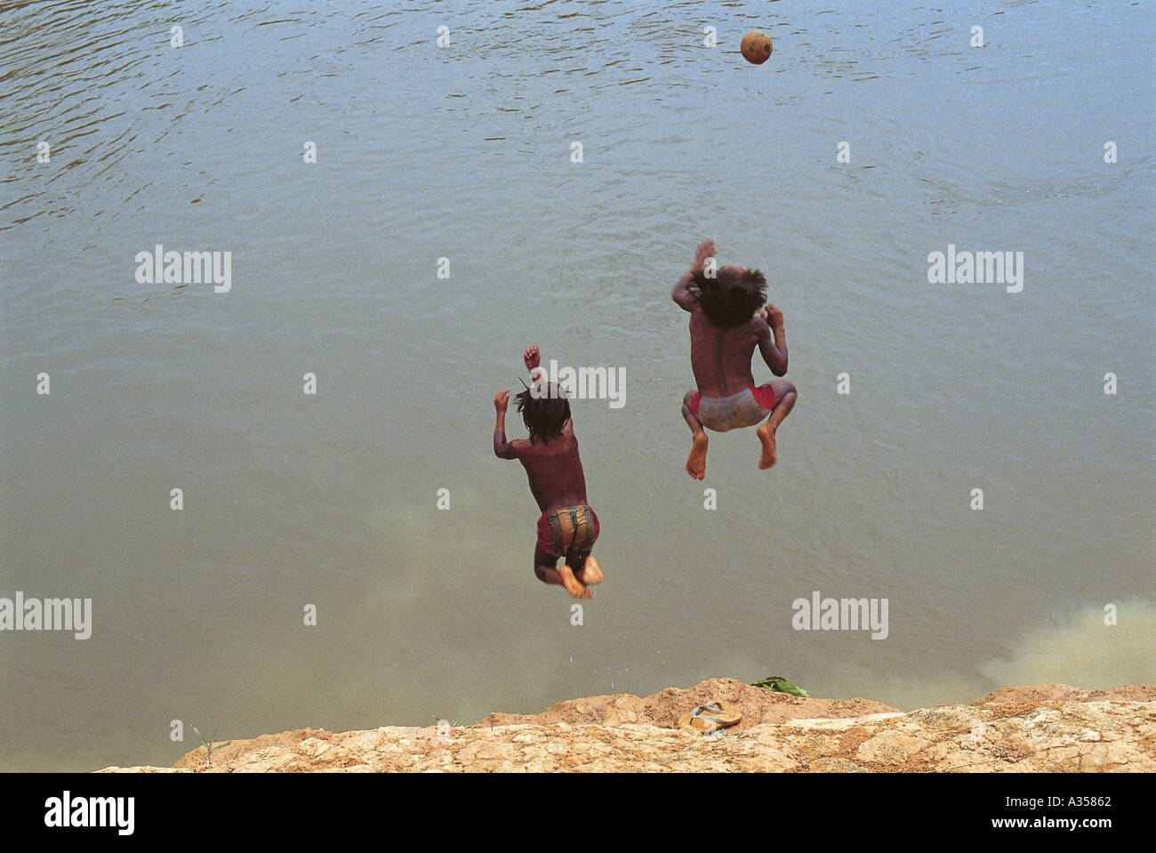 A ukre village Brazil Two Kayapo boys jumping into the river after a
