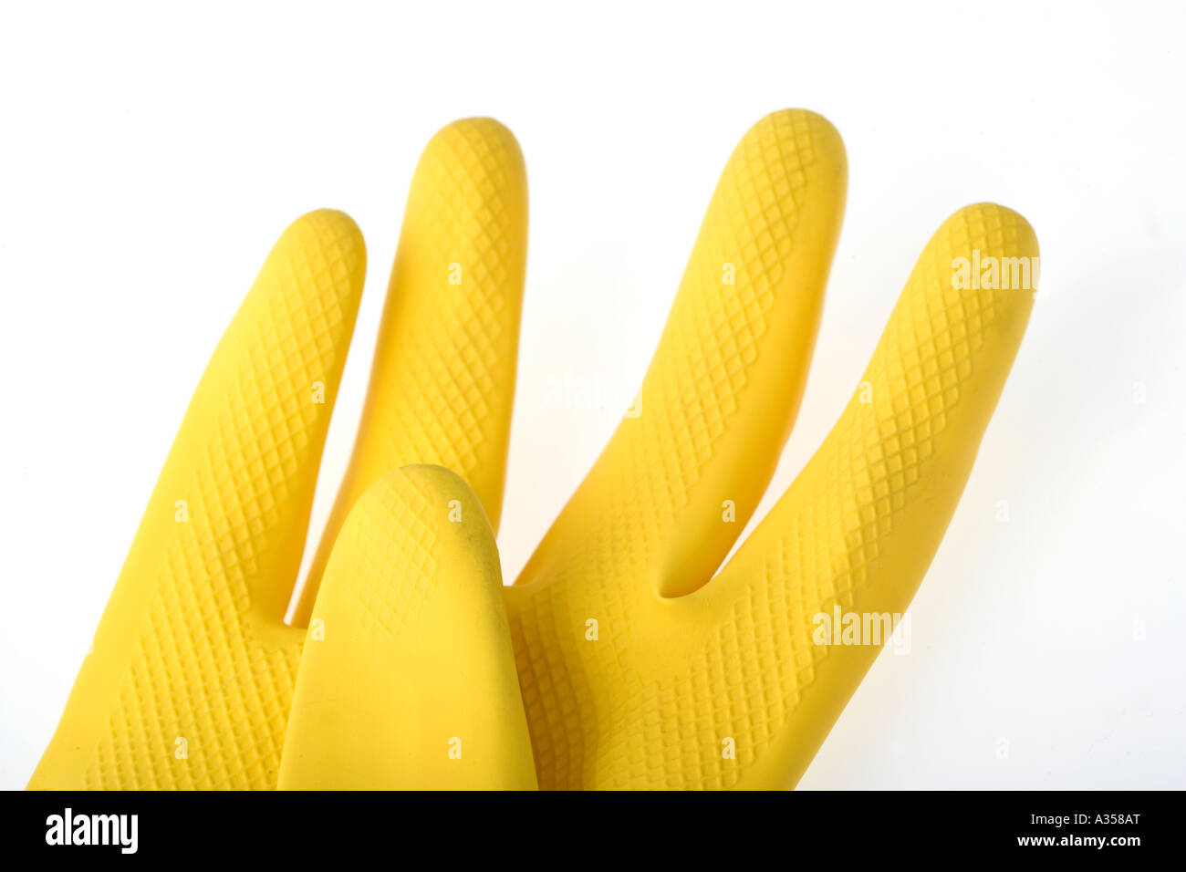 Yellow rubber dishwashing glove on white background Stock Photo Alamy