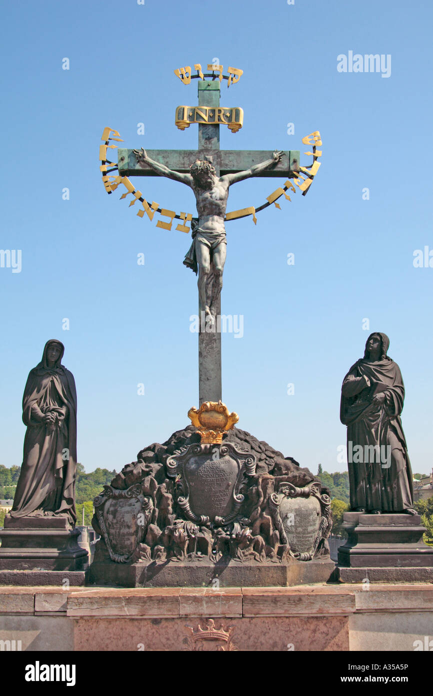 Crucifixion memorial on the Charles Bridge over the Vltava river, Prague Stock Photo