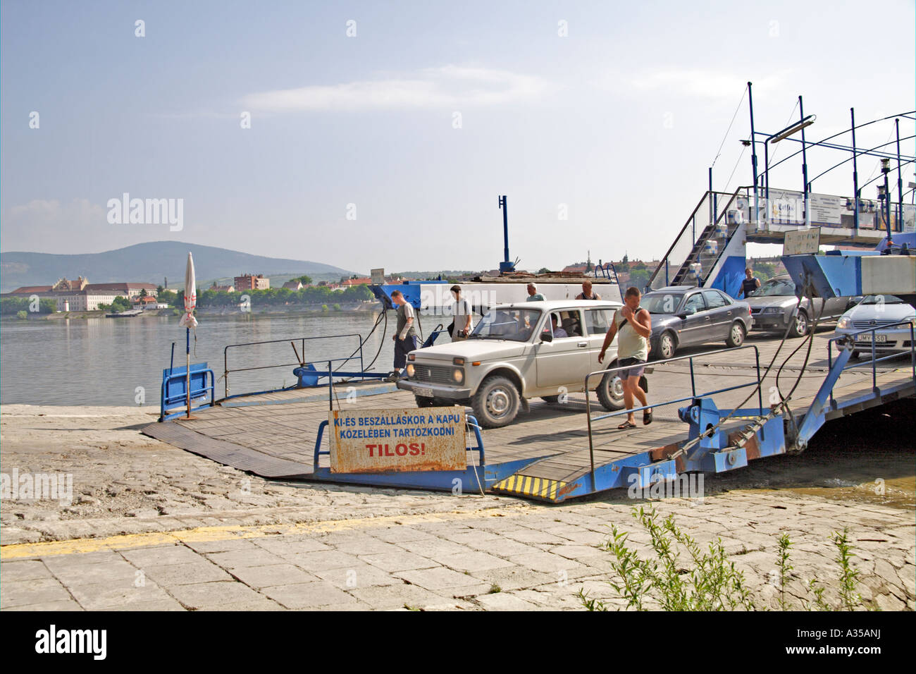 Vehicles and foot passengers disembarking from the Vac ferry on the west bank of the River Danube in Hungary Stock Photo