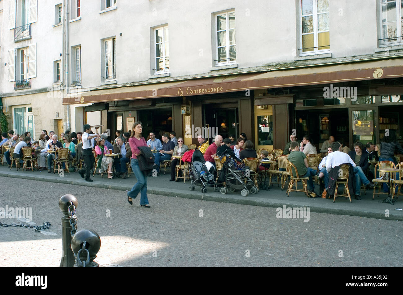 Paris France, Parisian street café scene  with Crowd of people sharing on Terrace  'Le Contrescarpe' Mouffetard District Stock Photo