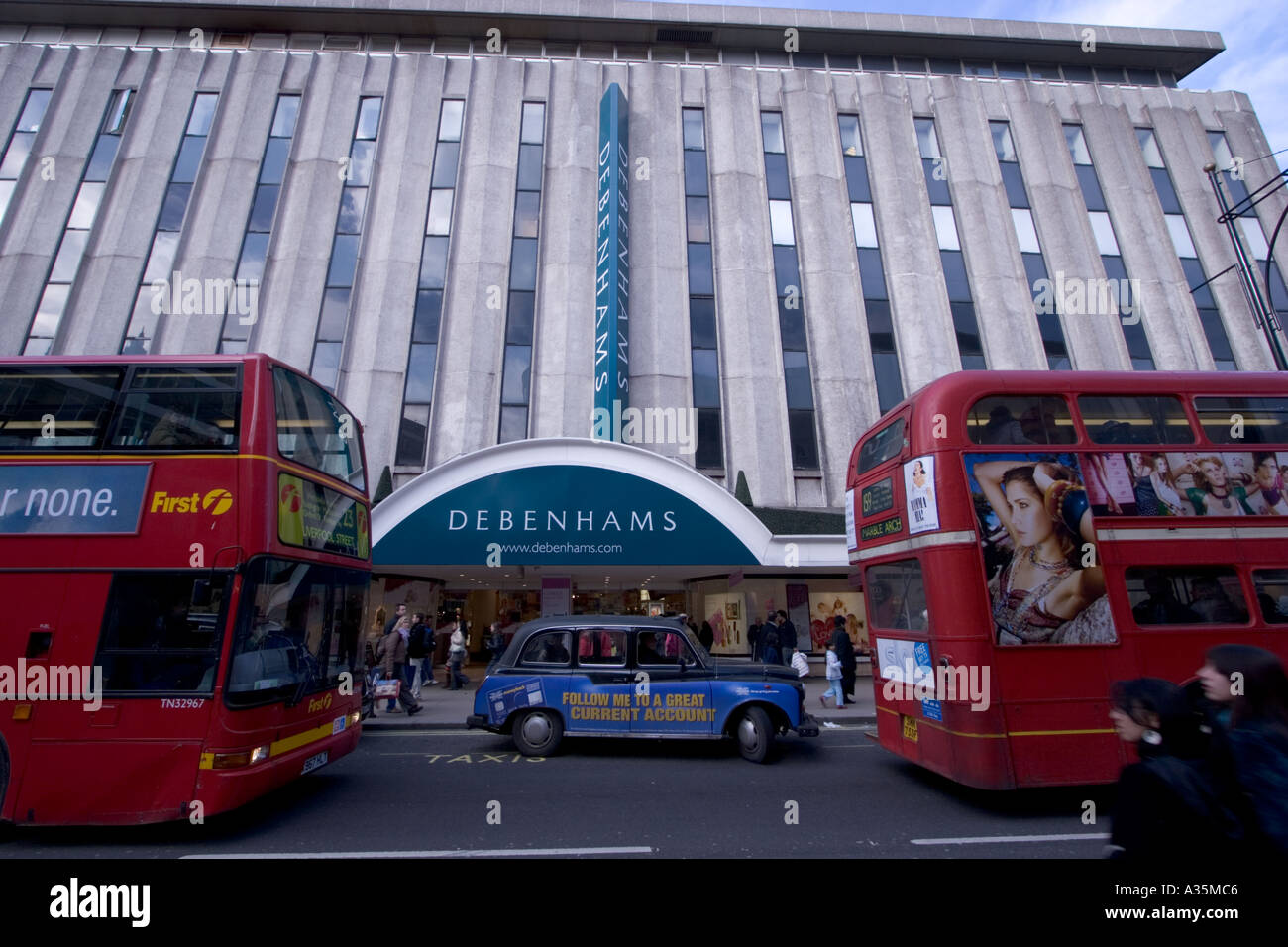 Exterior of Debenhams department store in Londons Oxford Street with London buses and taxi Stock Photo
