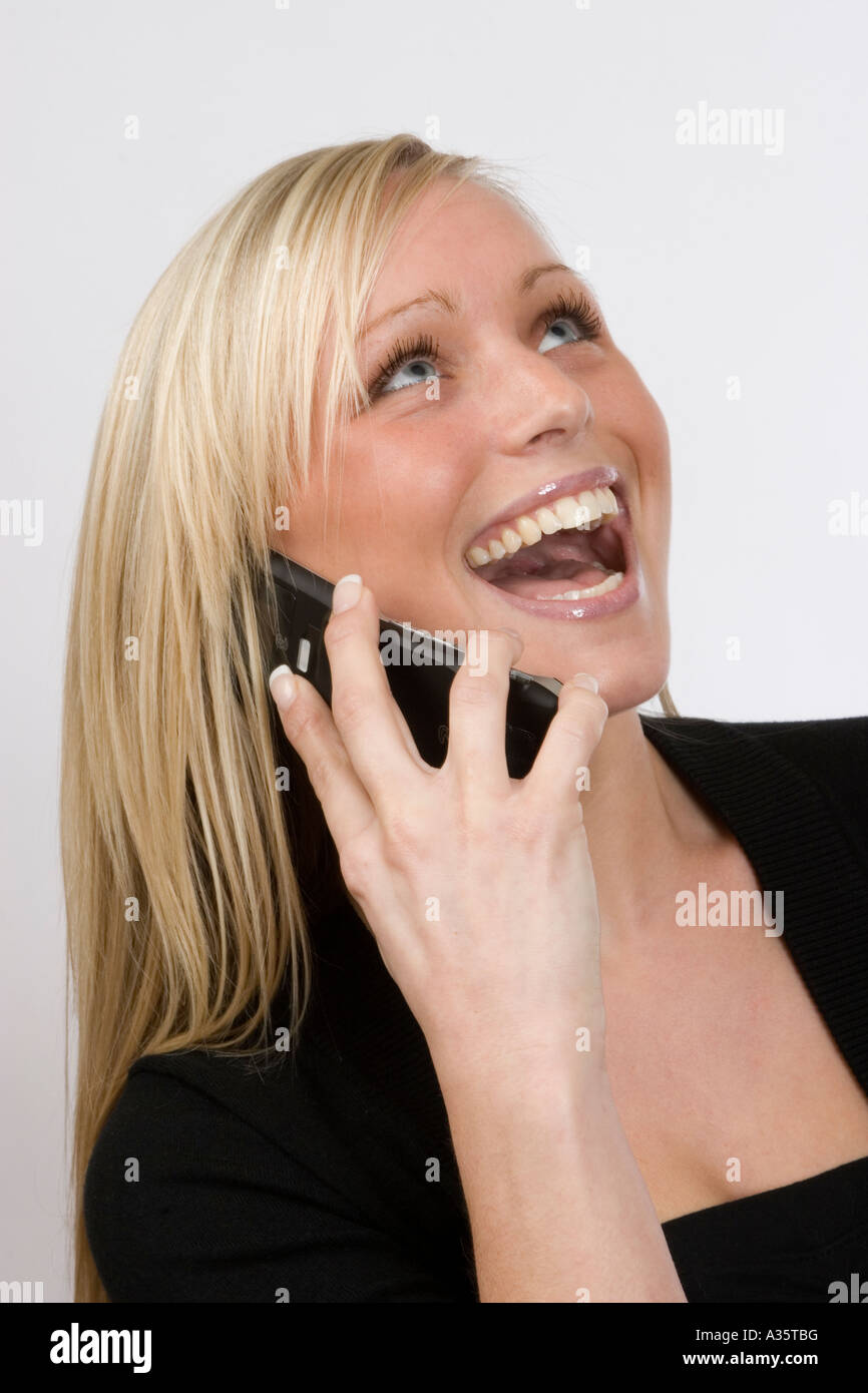 Young woman, laughing, using a Mobile Phone Stock Photo