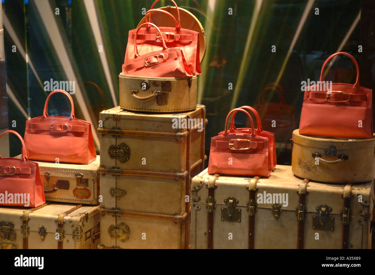 Designer luggage in fashion shop window display in Milan Stock Photo