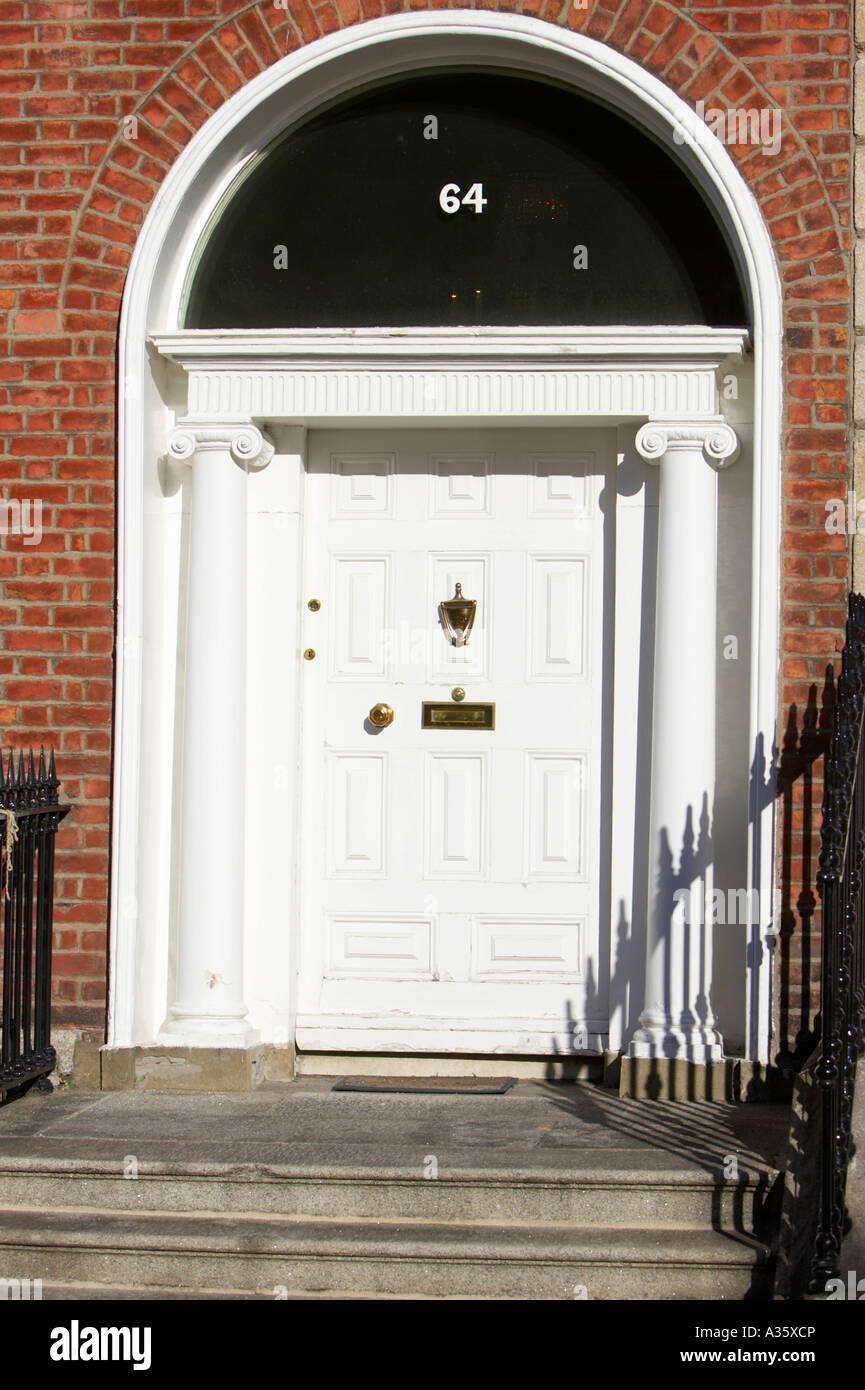 white door with brass letterbox door knob and knocker in