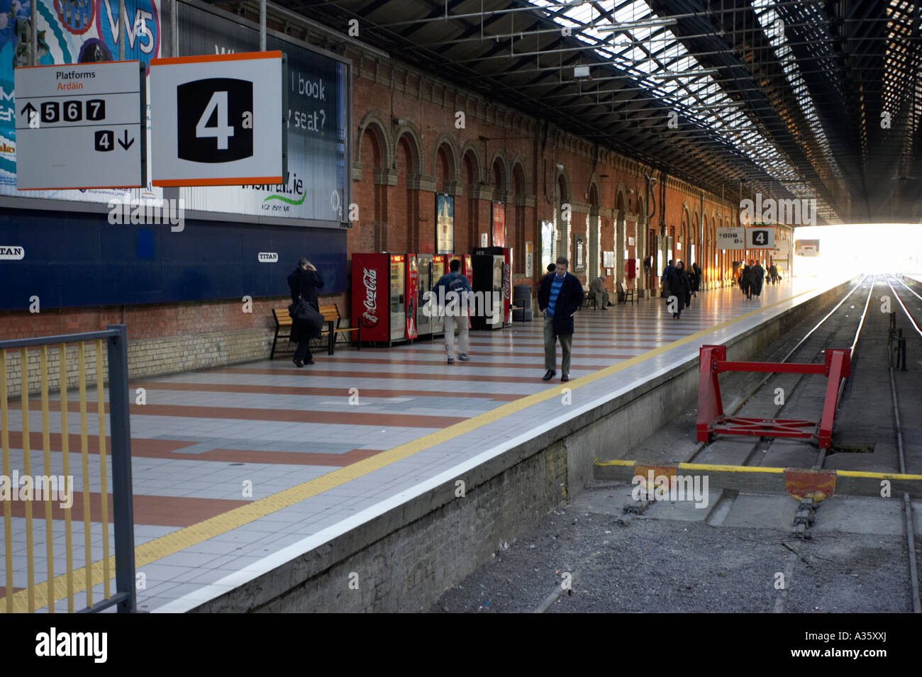 platform 4 and passengers and rail track at Connolly iarnrod eireann station in Dublin Stock Photo