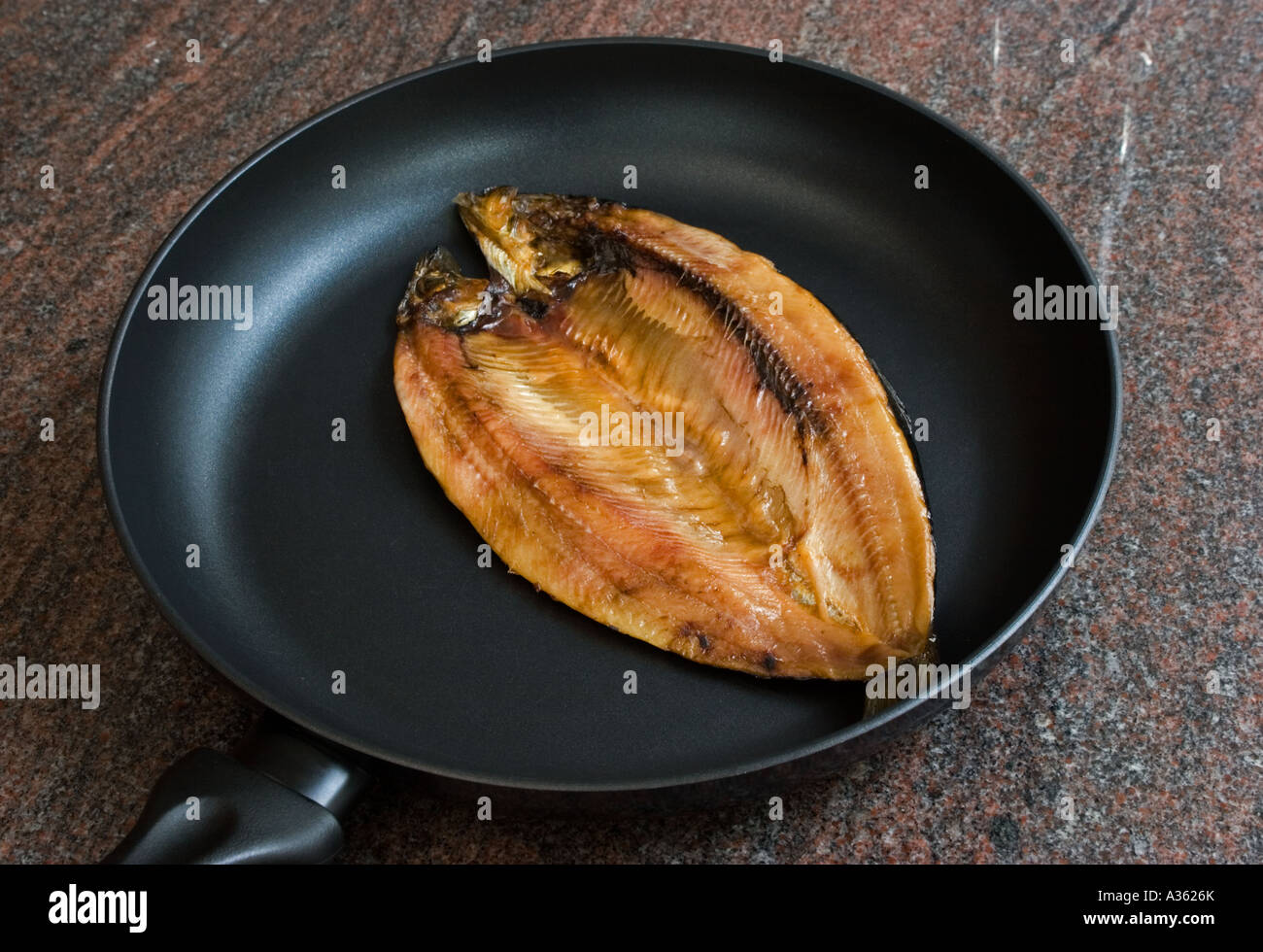 Kippers in a frying pan Stock Photo Alamy