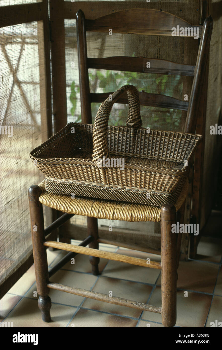 Closeup of old wicker basket on antique French rushseated dining