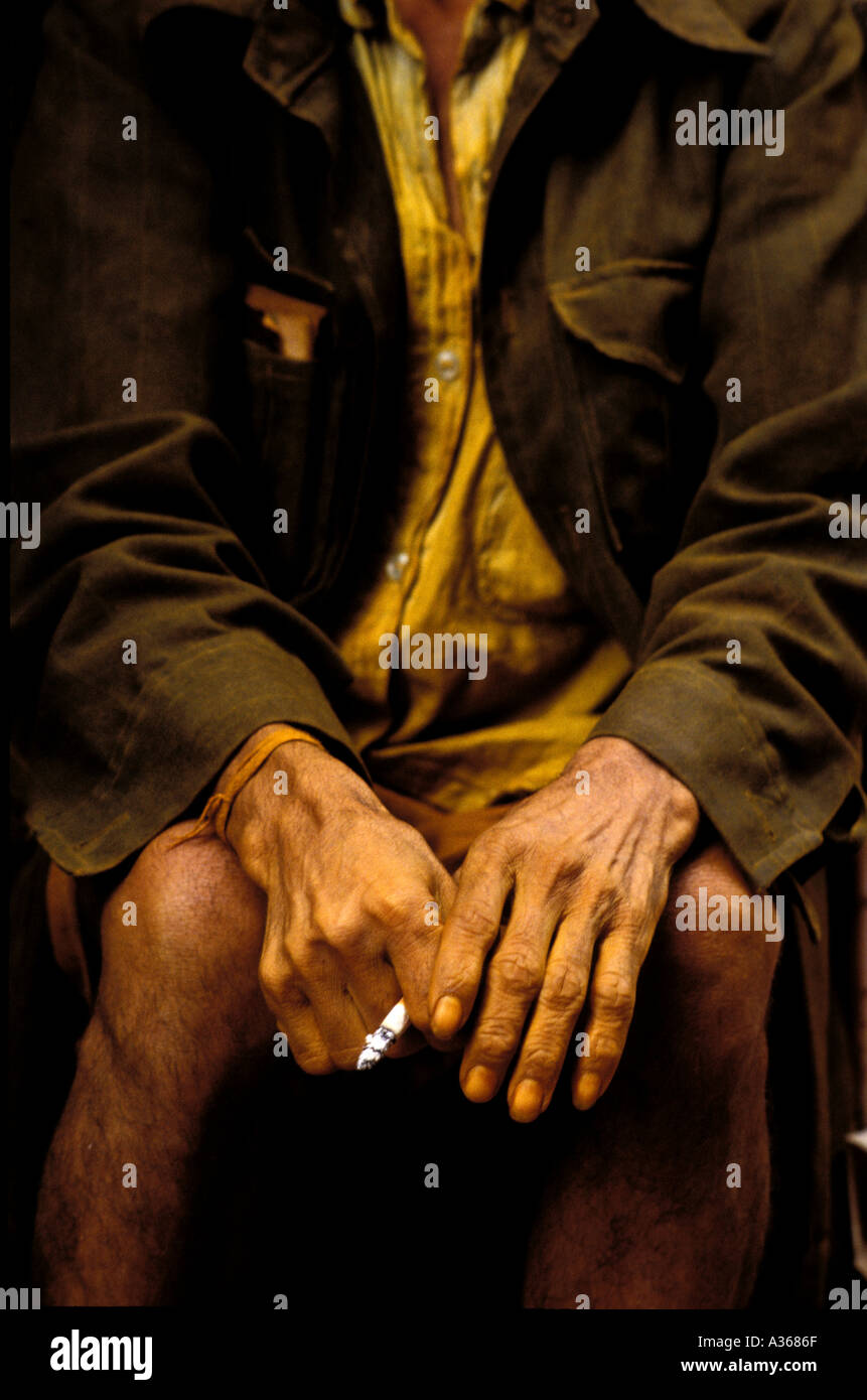 detail tumeric seller holding a cigarette in his yellow stained hands Kathmandu Nepal Stock Photo