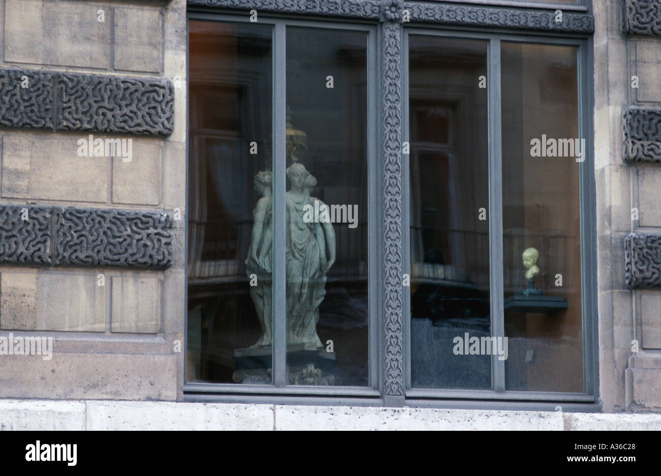 Sculptures in window of the Louvre Stock Photo