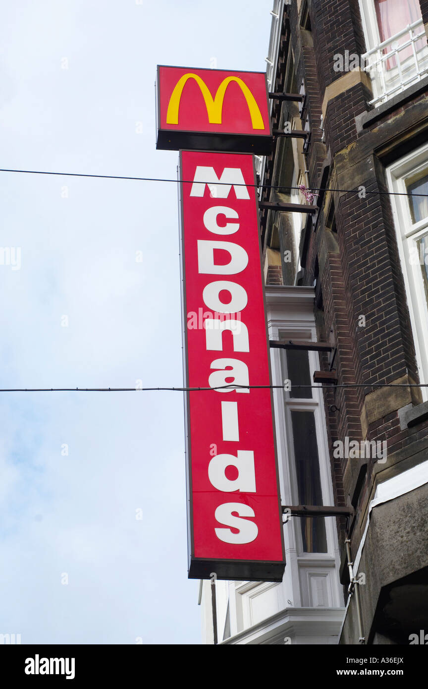 World-famous golden arches logo on a McDonald's sign, on a fast food restaurant building in Amsterdam. Stock Photo