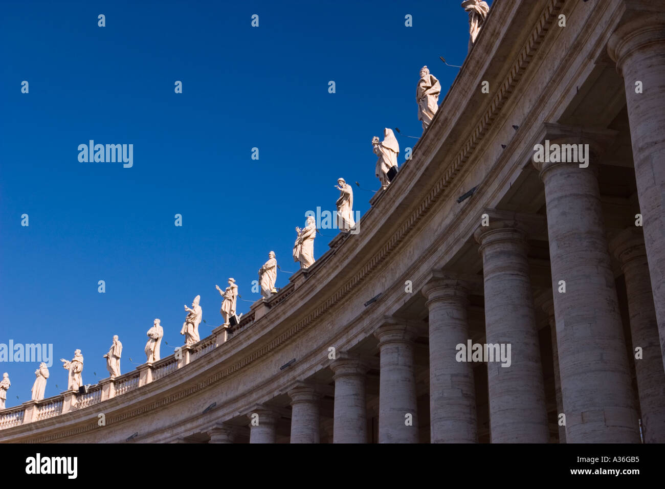 Statues of saints atop the colonnades of St Peters Square Stock Photo