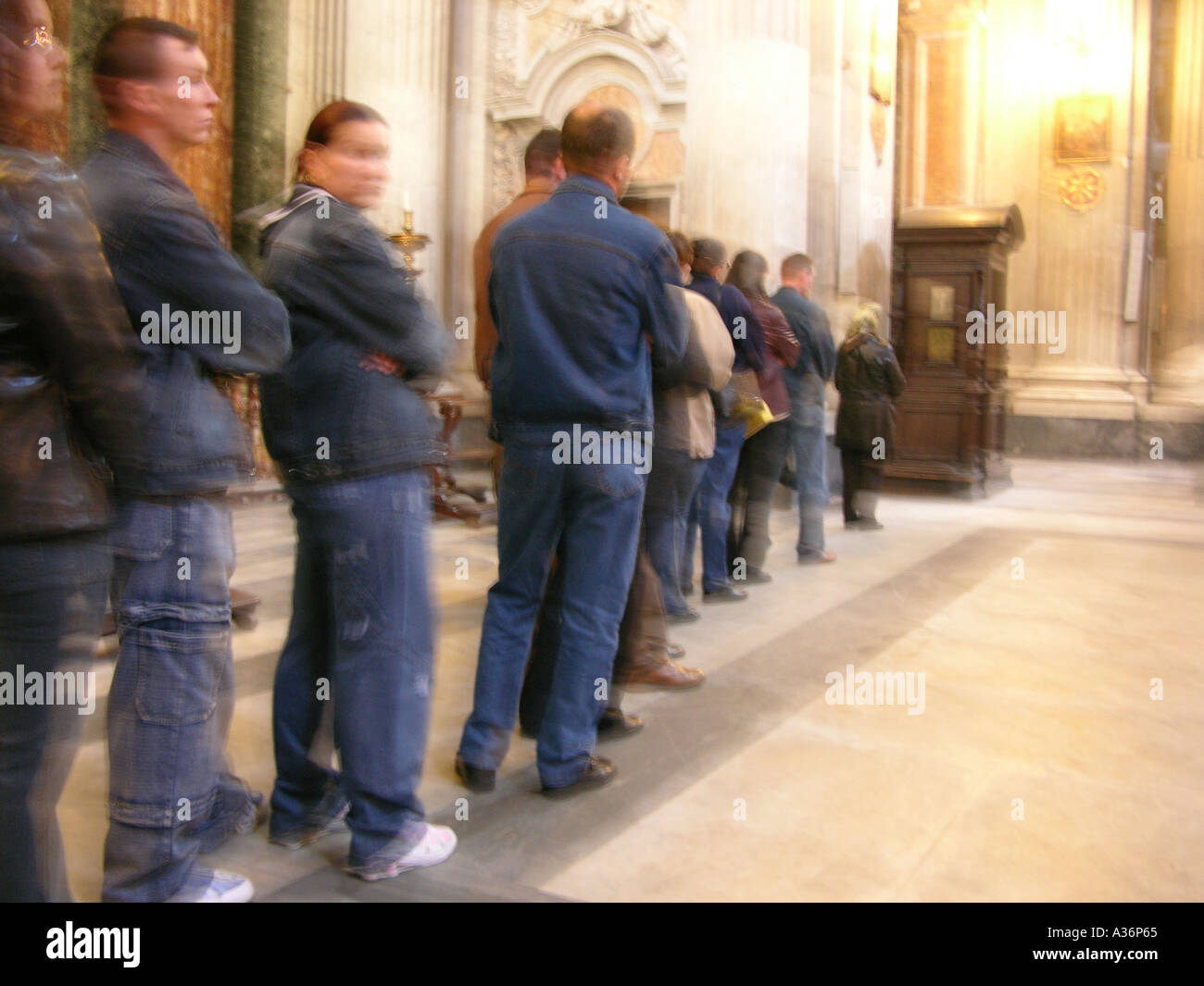 Queue of people waiting to confess Stock Photo