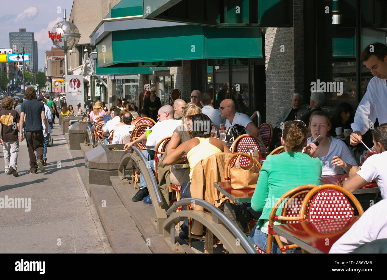 People eating and drinking in street cafe / restaurant on St. Catherine Street in Montreal, Quebec, Canada. Stock Photo