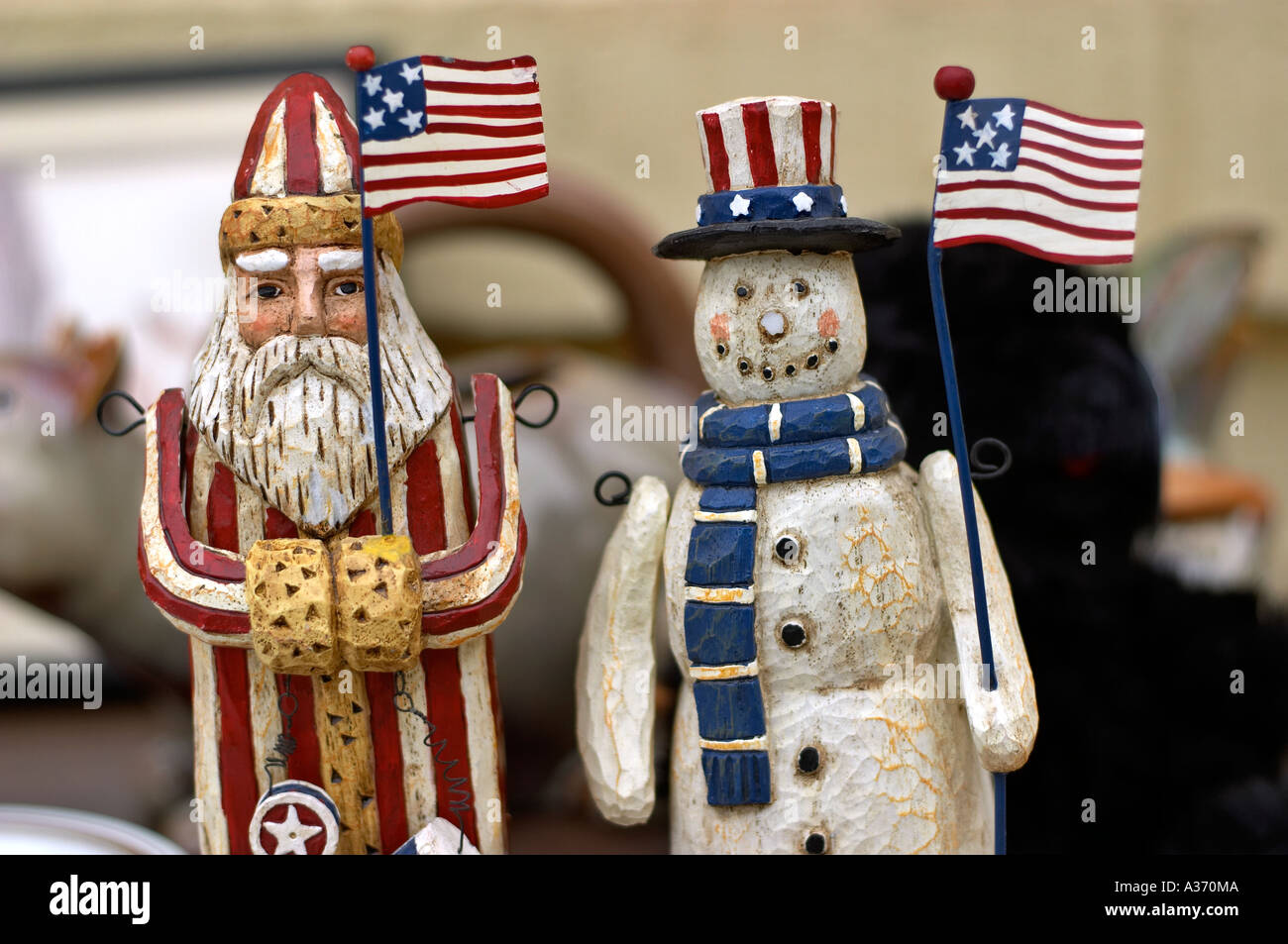 Patriotic Santa and Snowman holding American US flags. Striped outfits and hats reinforce the patriotic notion. Stock Photo
