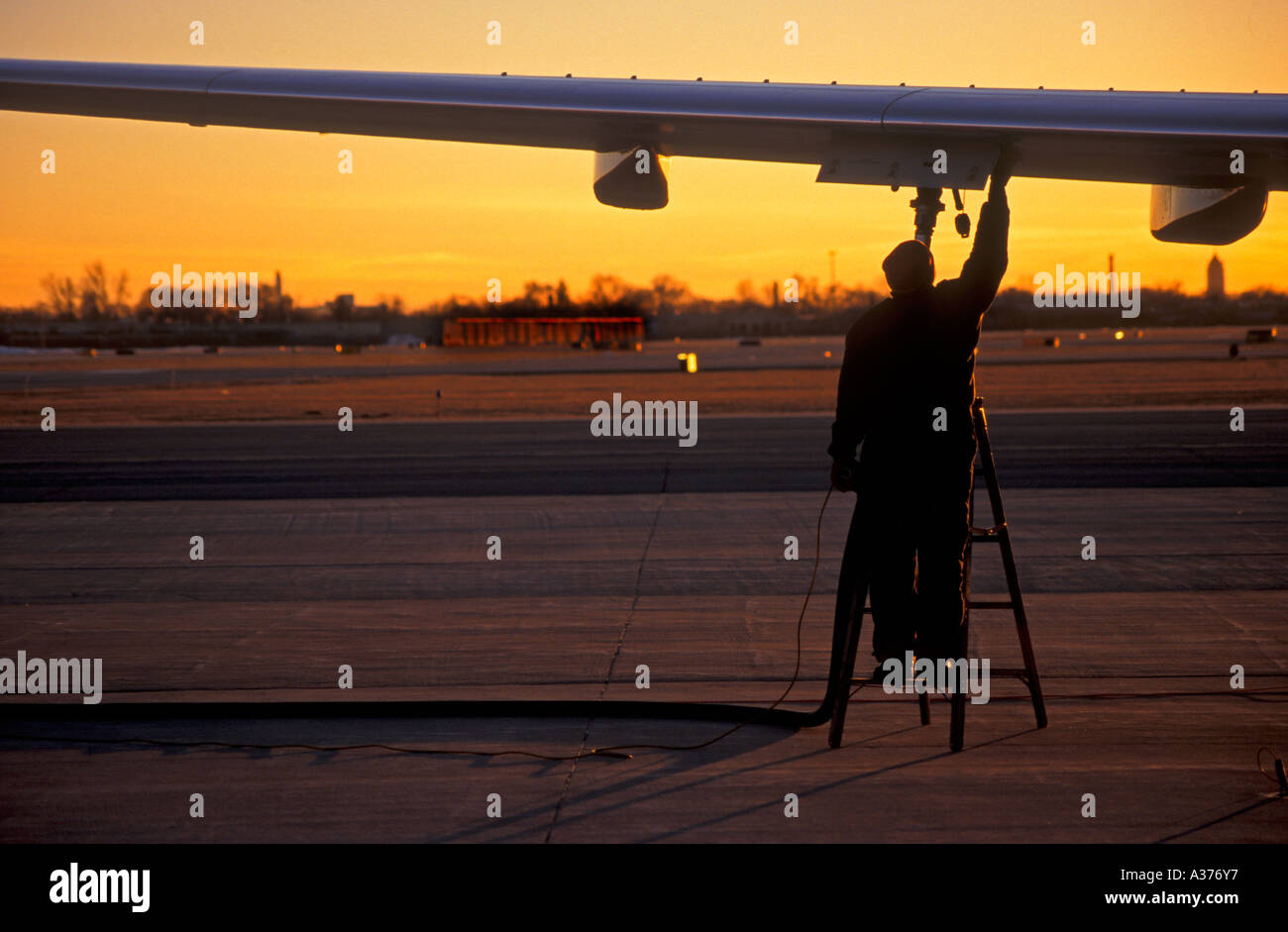 Detroit Michigan A ground worker fuels a Boeing 737 at Detroit City Airport Stock Photo