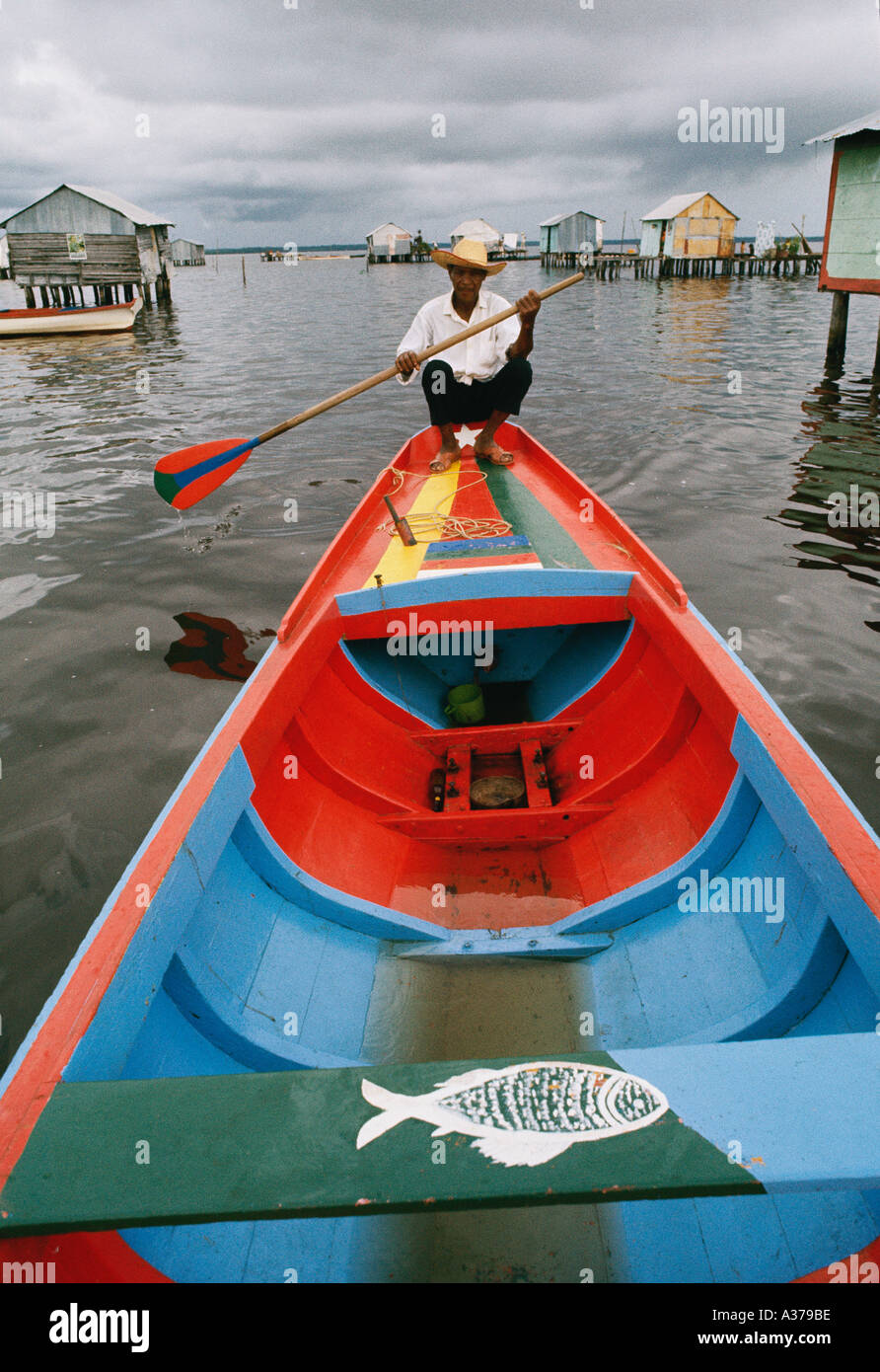 Dweller of stilt houses in Lake Maracaibo in Venezuela using his fishing boat for transportation Stock Photo