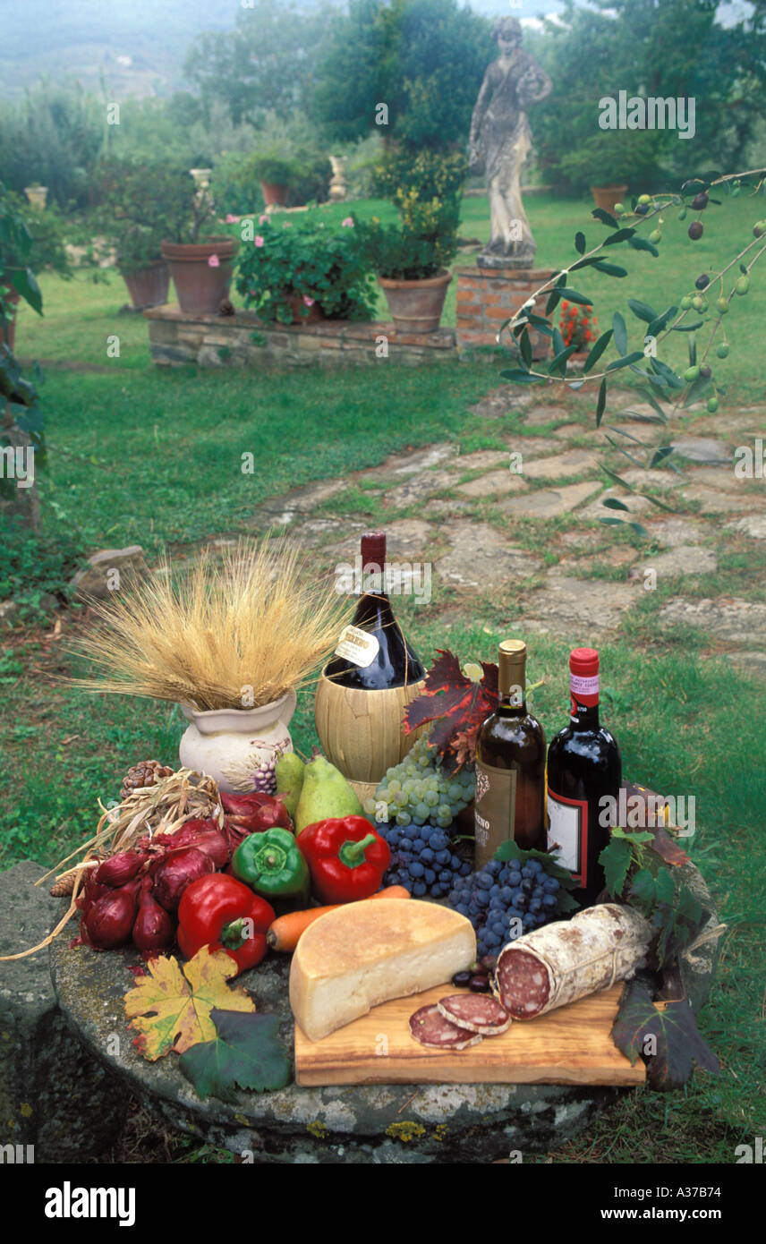 Chianti wines on table in garden with variety of foods at the Terreno vineyards in Tuscany Italy Stock Photo