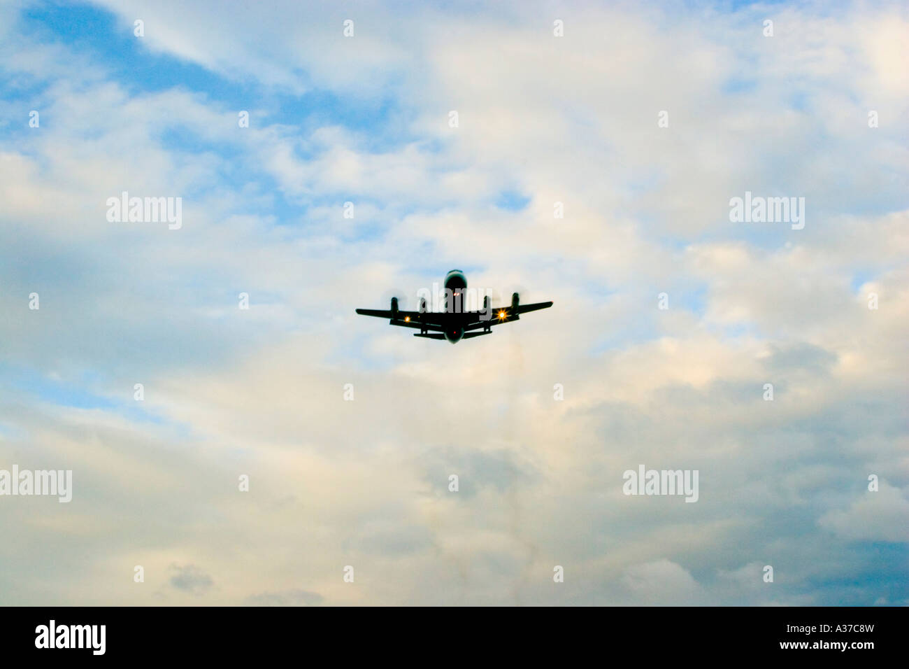 A plane in the sky decending to land at Edinburgh airport Stock Photo