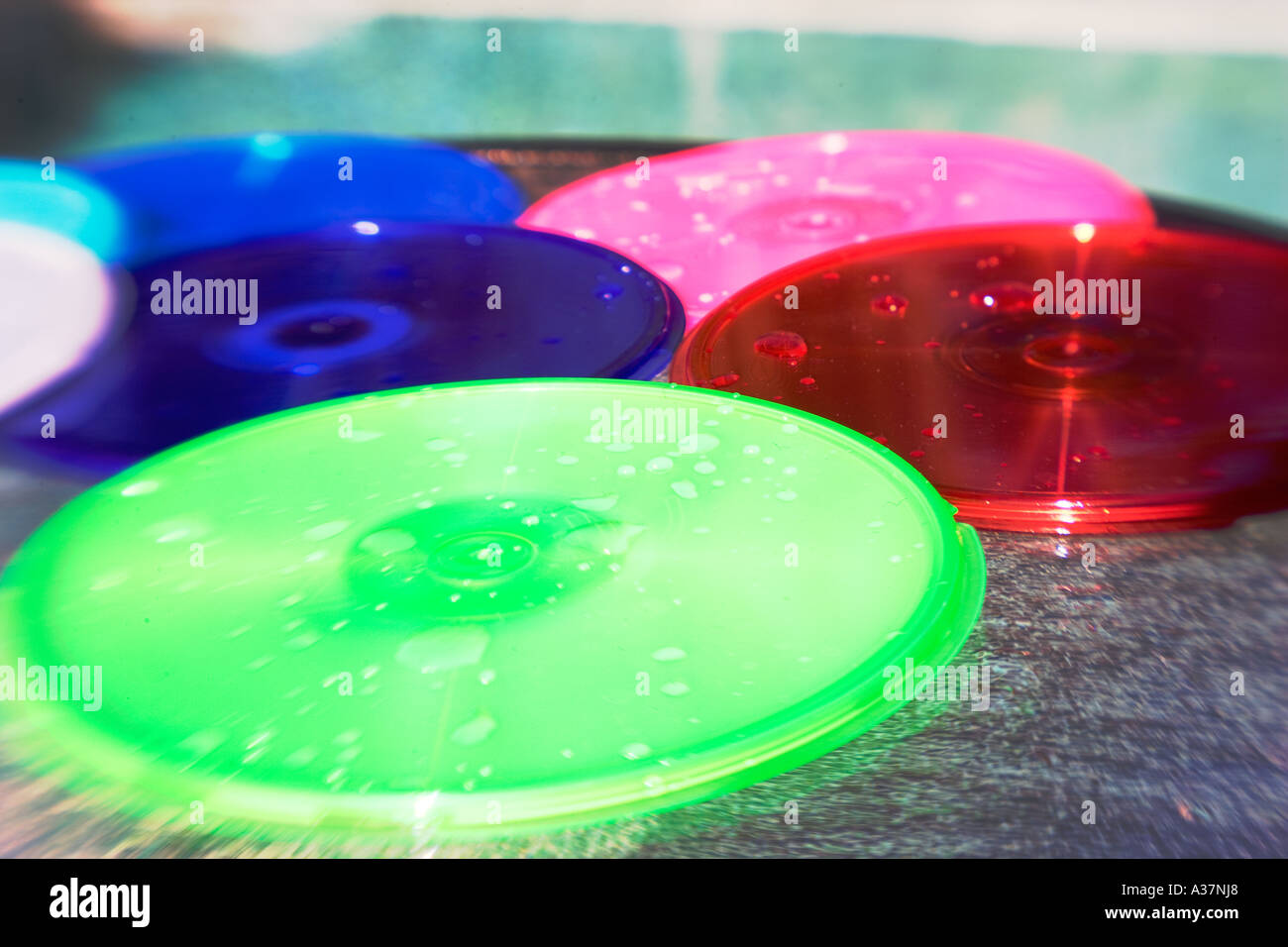 CD DVD container PODZ product beside pool splashed with water Stock Photo