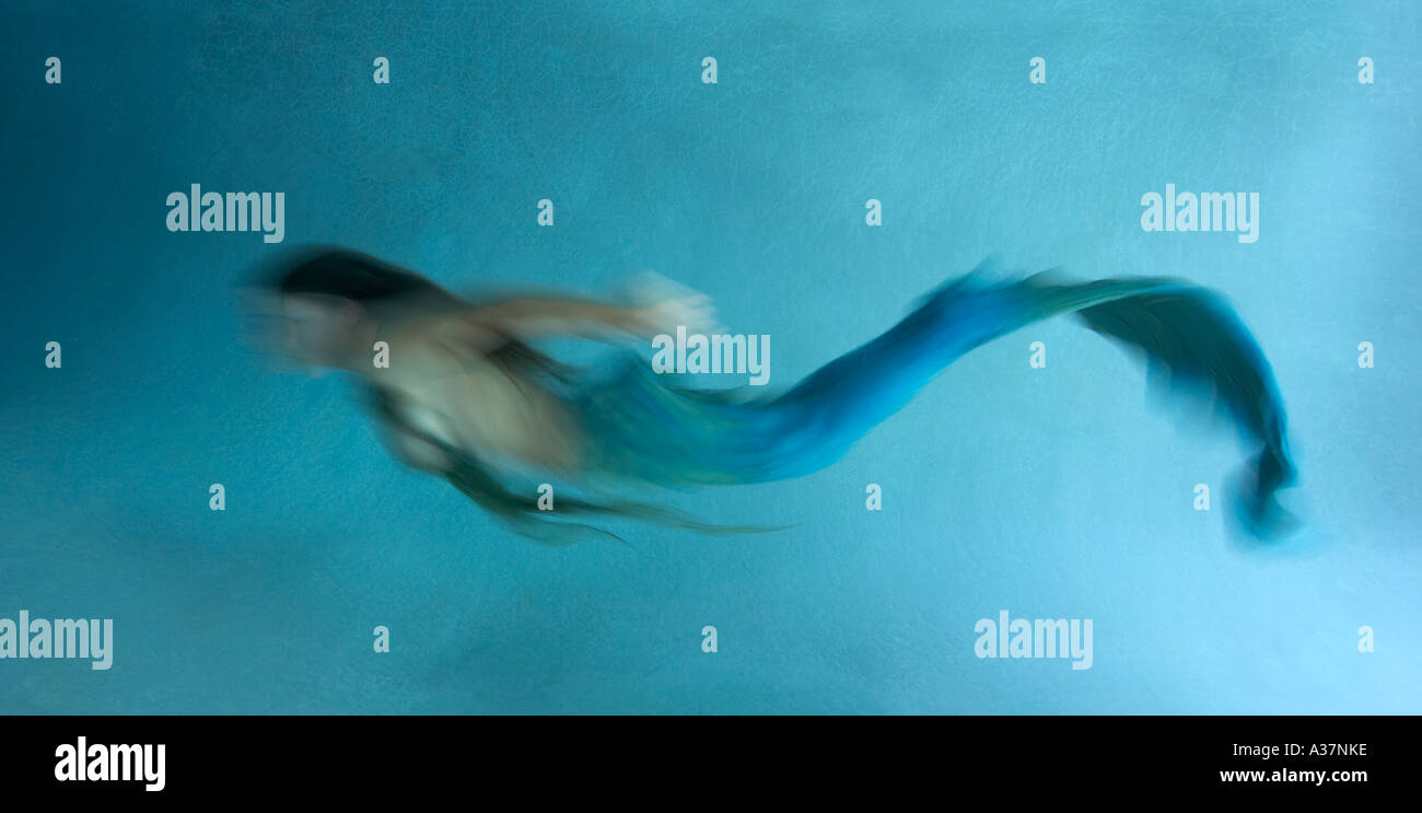Mermaid underwater in low light blurred action Stock Photo