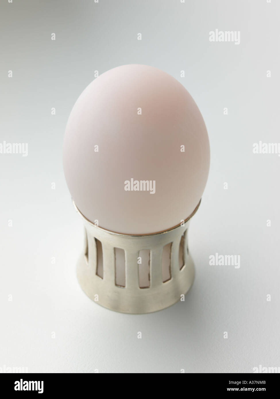 White boiled egg in a silver egg cup Stock Photo