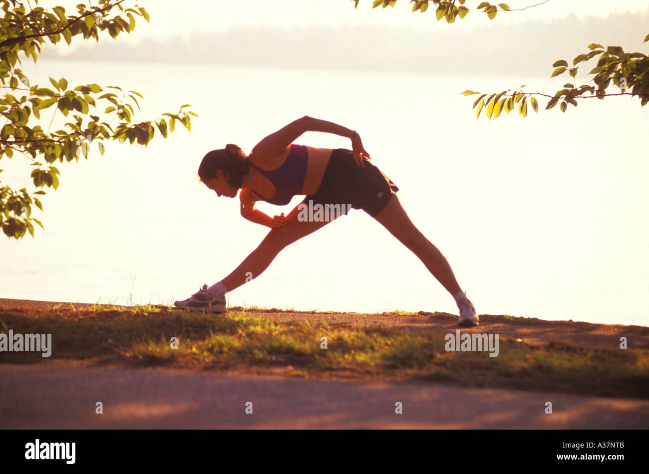 Woman fitness runner stretching hi-res stock photography and images - Alamy