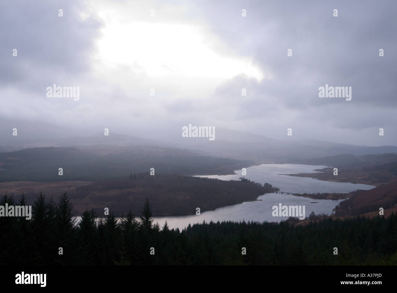 The shape of Loch Garry on the road north from Invergarry appears like the map of Scotland under a typical stormy winter sky Stock Photo