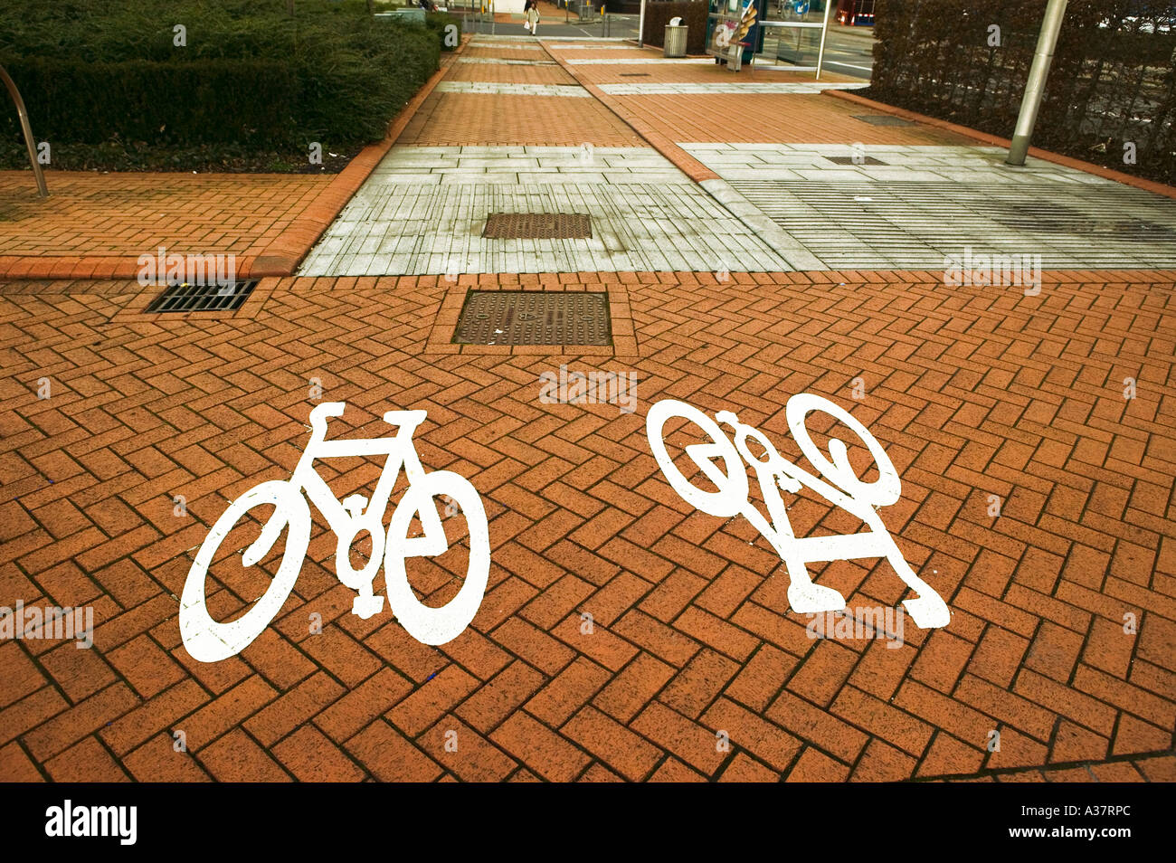 Cycling signs on pavement indicating cycle path Cardiff Bay Wales UK