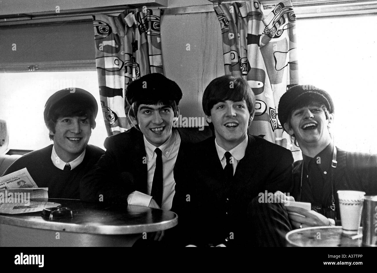 BEATLES On a train during their August 1964 tour in America from left John Lennon, George Harrison, Paul McCartney, Ringo Starr Stock Photo