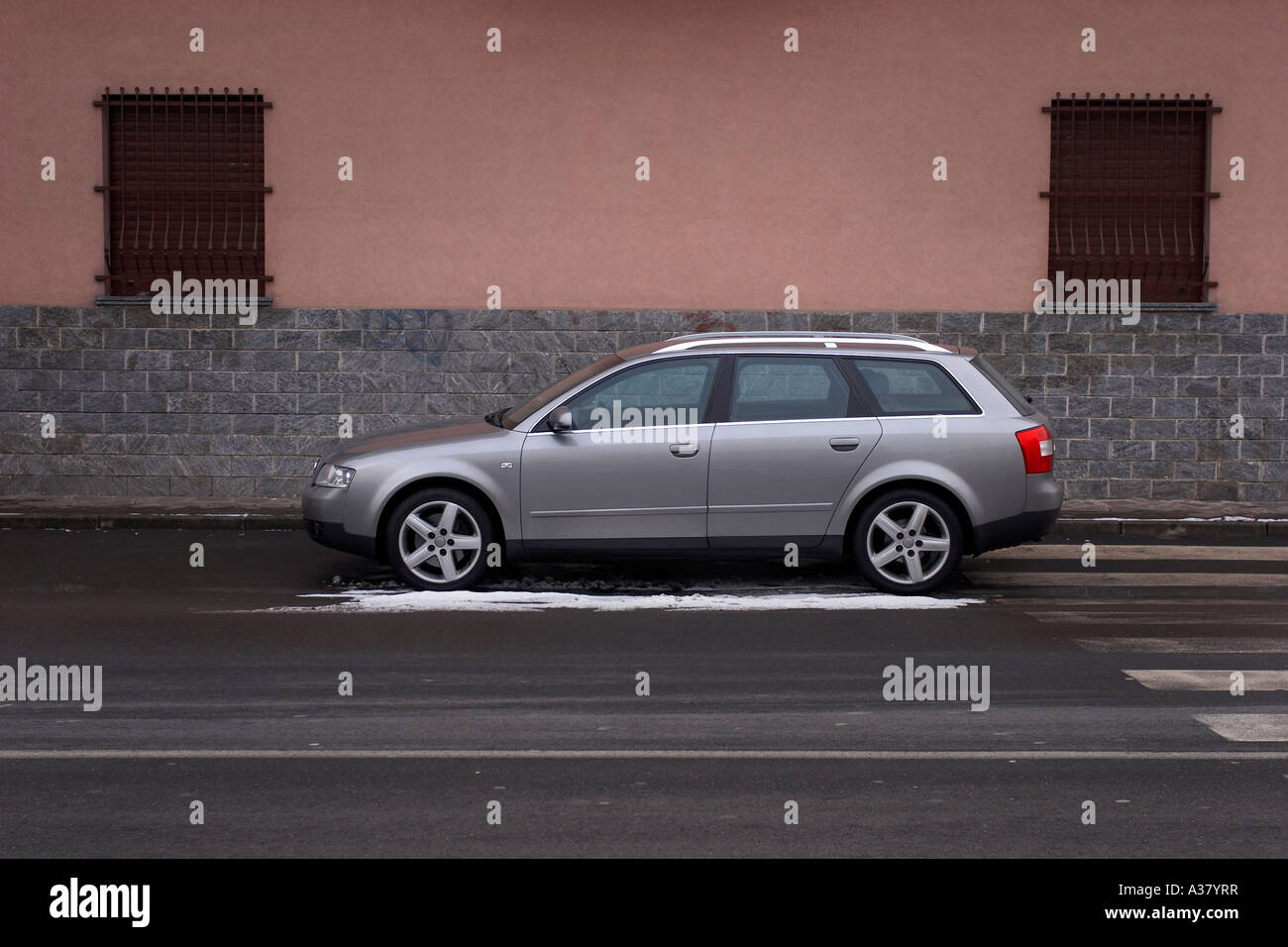 Silver Audi A4 parked in Italy with snow Stock Photo