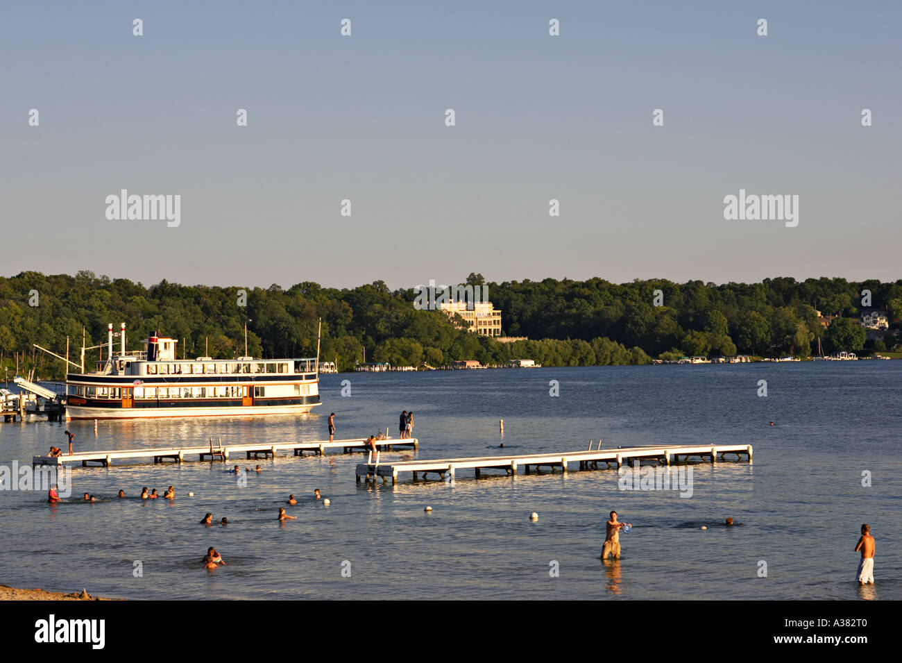 WISCONSIN Lake Geneva Paddlewheel tour boats at dock people on beach