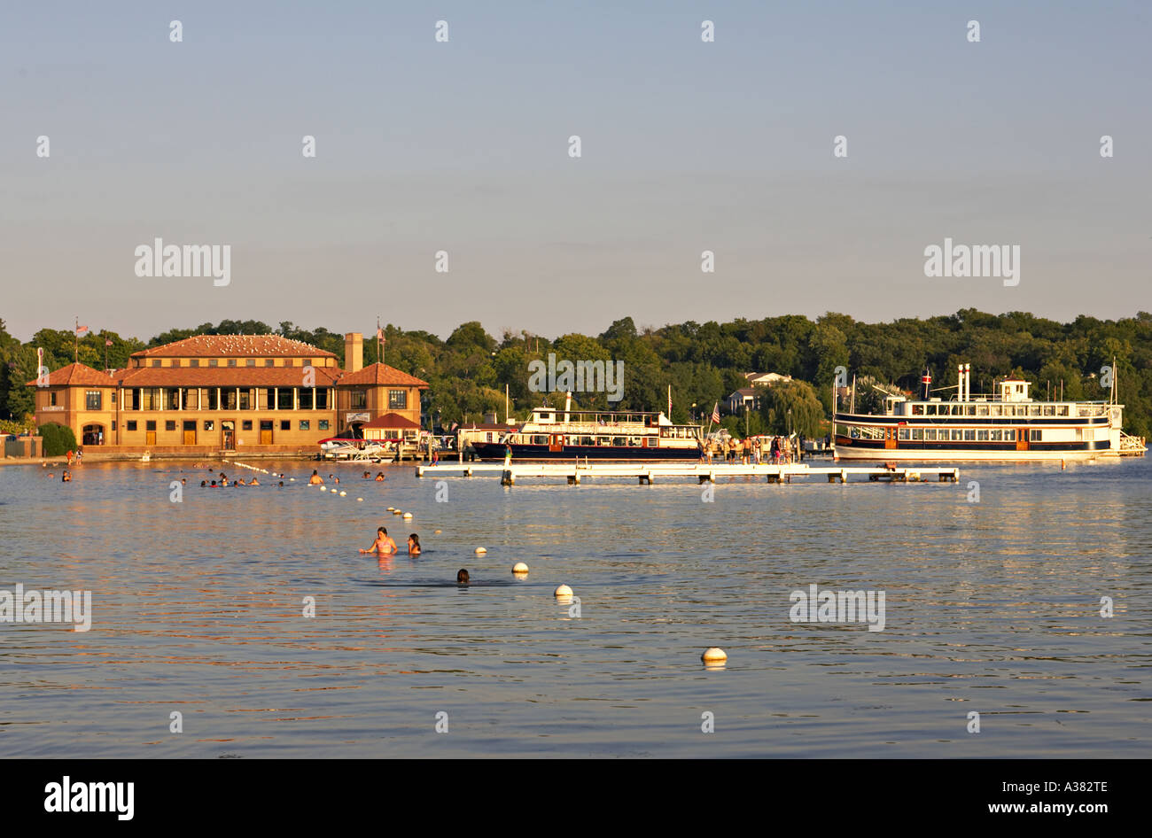 WISCONSIN Lake Geneva Paddlewheel tour boats at dock people swimming