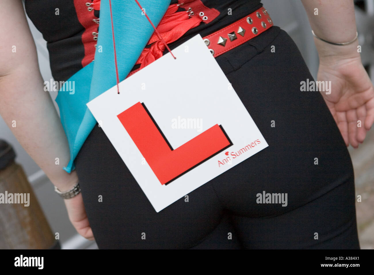 Ann Summers L Plate, being worn by woman.  The rear bum of bride to be on hen night, UK Stock Photo