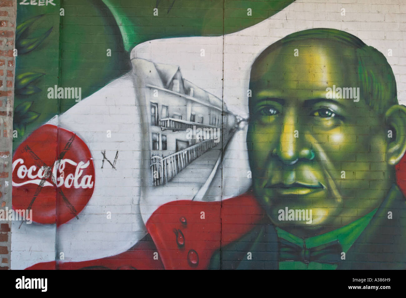 STREET SCENE Chicago Illinois Hispanic theme mural in Pilsen neighborhood slash through Coca Cola sign Stock Photo